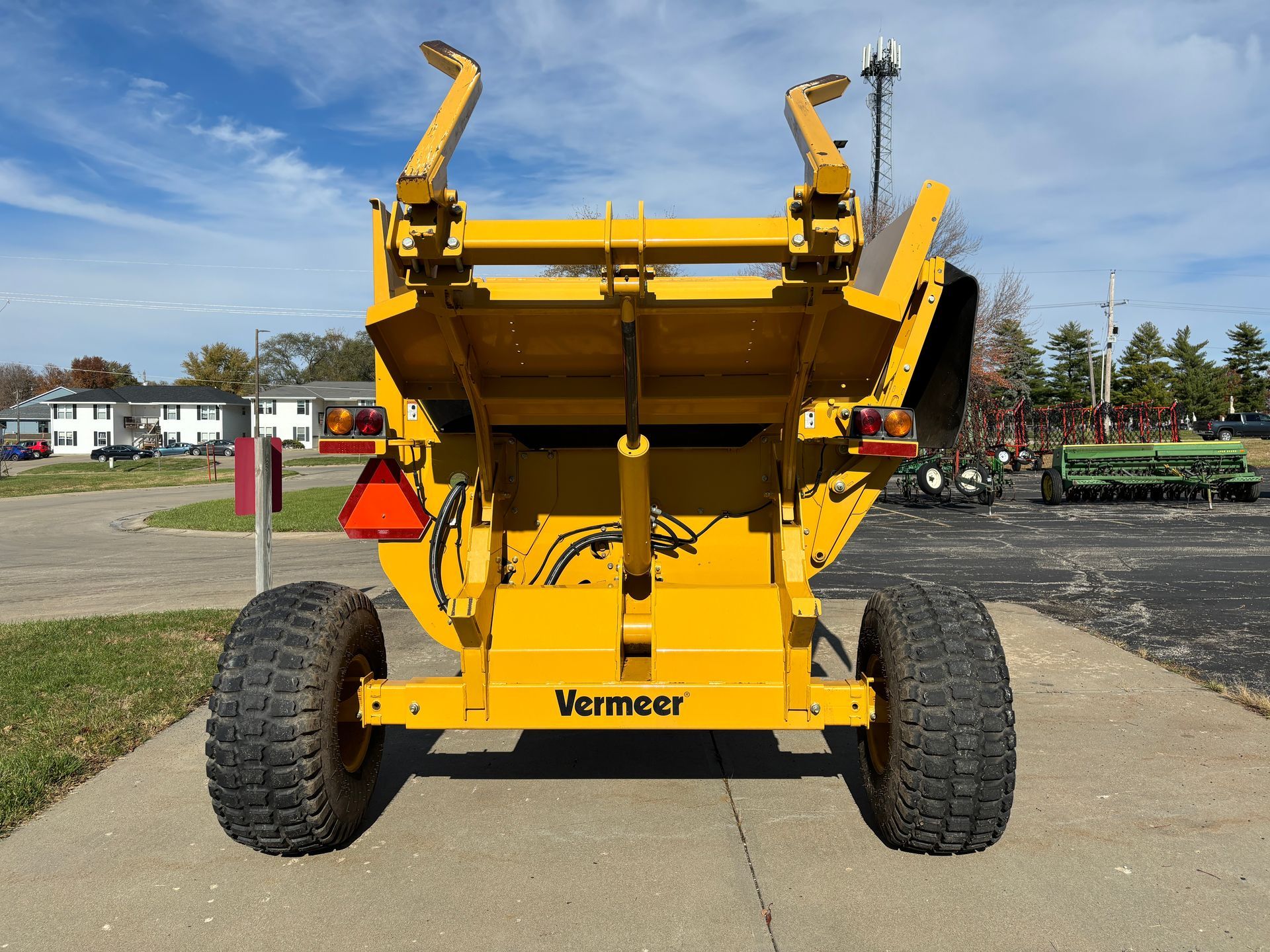 Yellow bale processor on a paved surface, back shot.