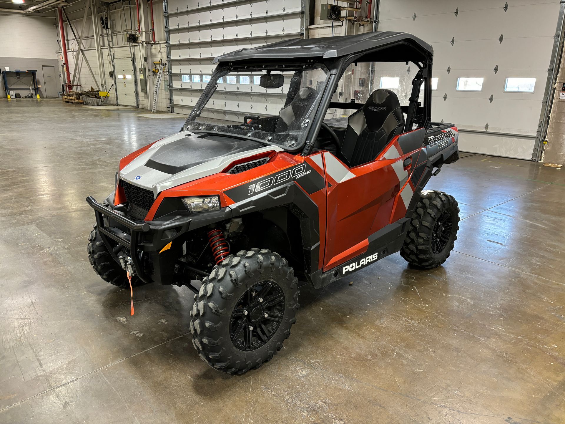 Red and black Polaris General side-by-side utility vehicle.
