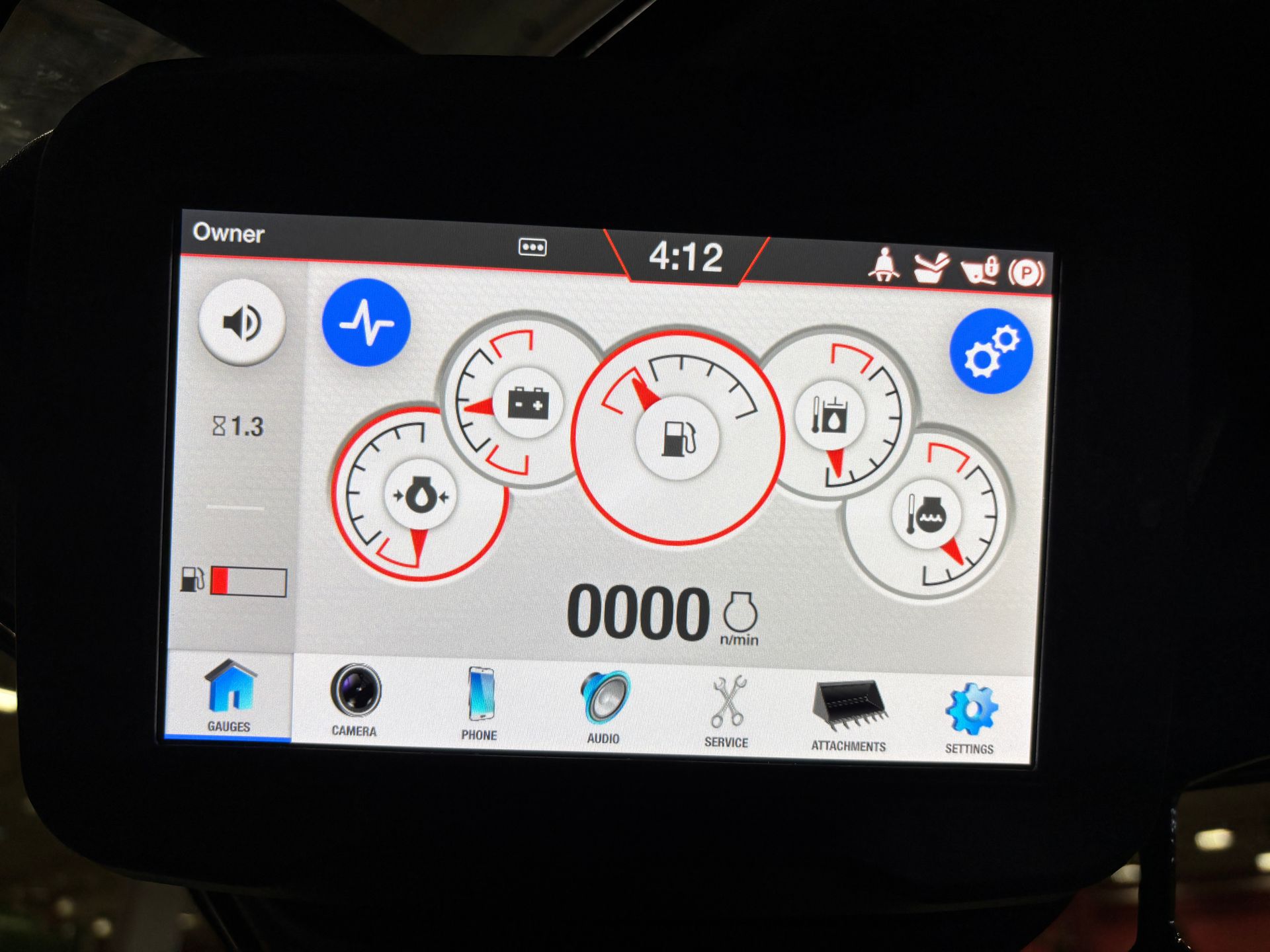 Dashboard displaying gauges, 4:12 time, and system icons. Red and blue accents on a grey screen.