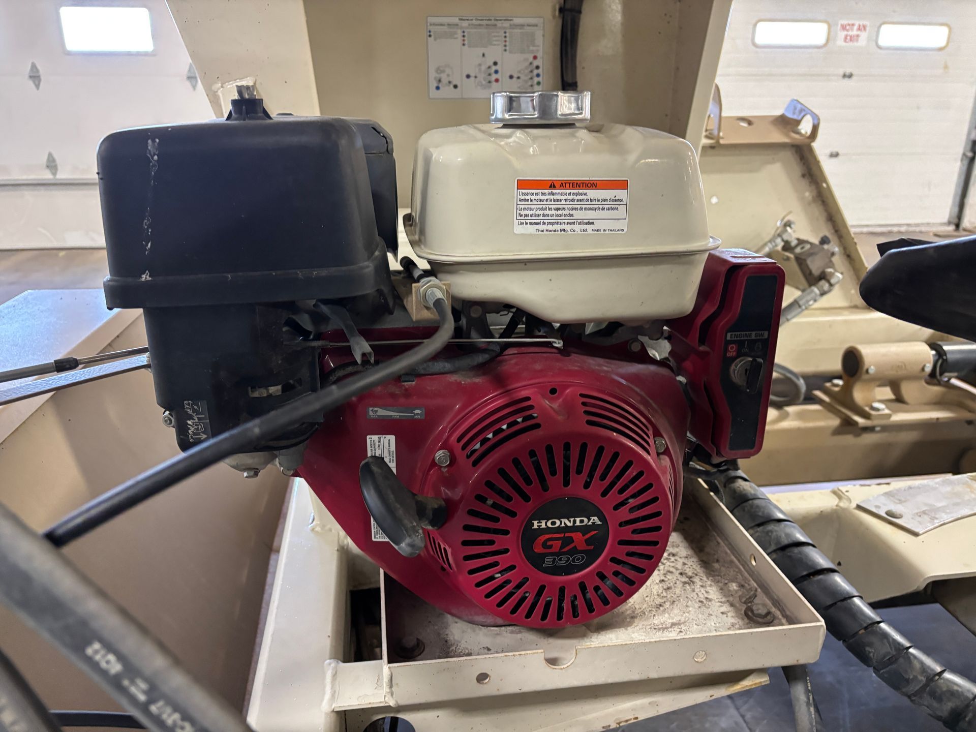 Honda GX270 engine, red and beige, mounted on machinery. Black air filter and fuel tank visible.