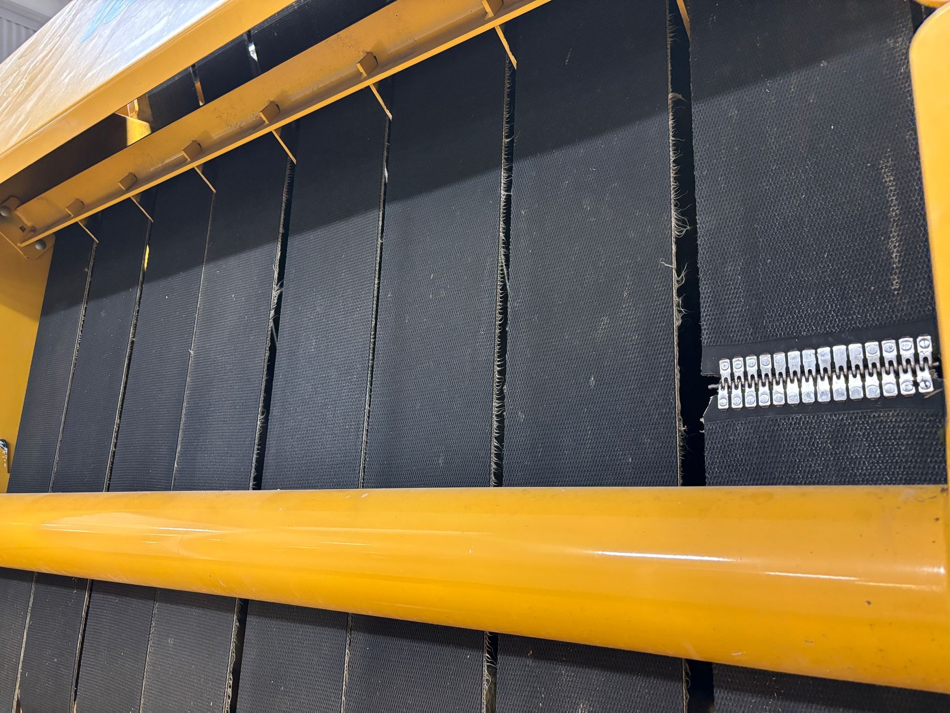 Close-up of a machine's black, ridged filters in a yellow frame.
