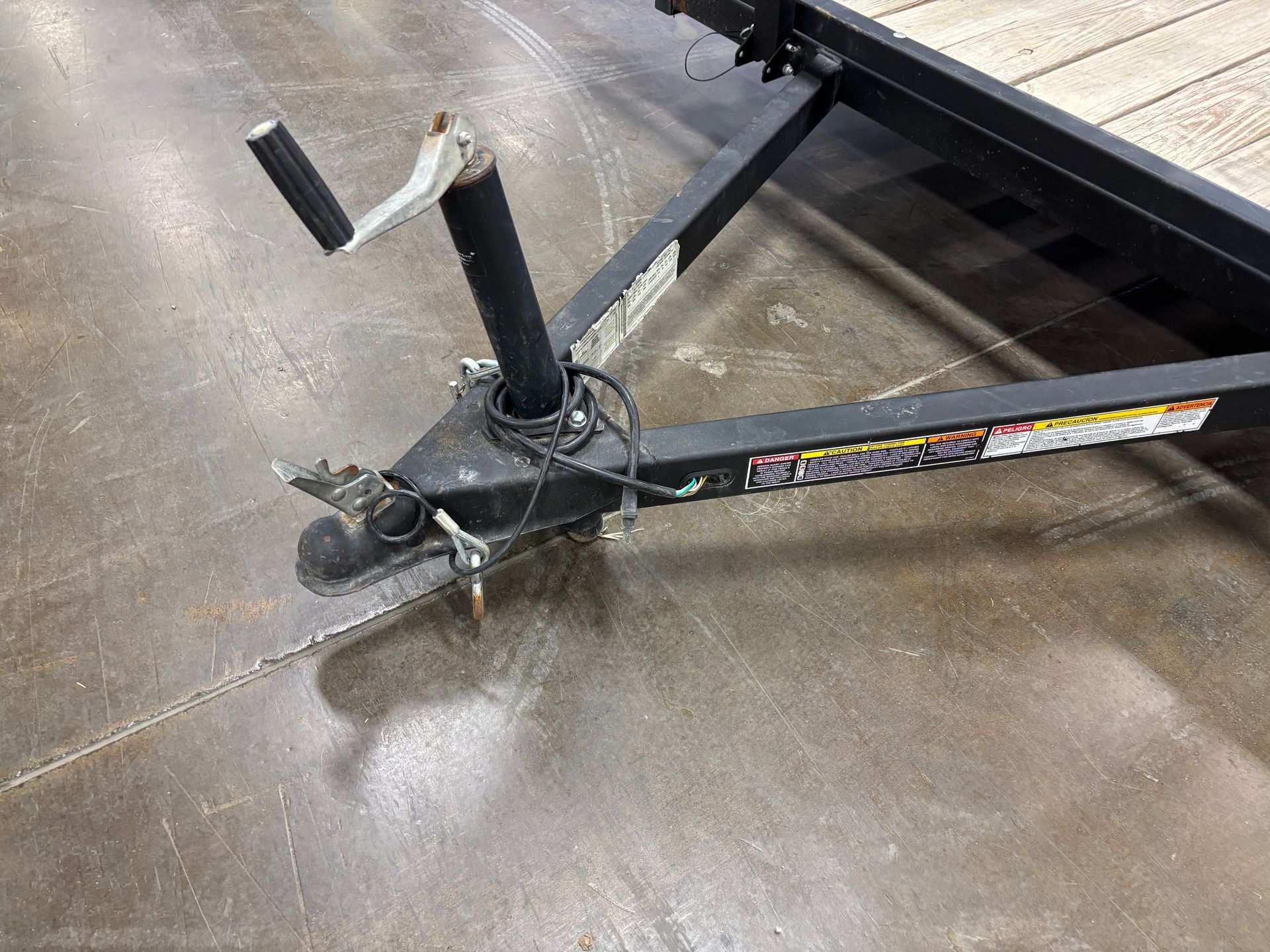Trailer hitch with a black frame and a damaged coupler.