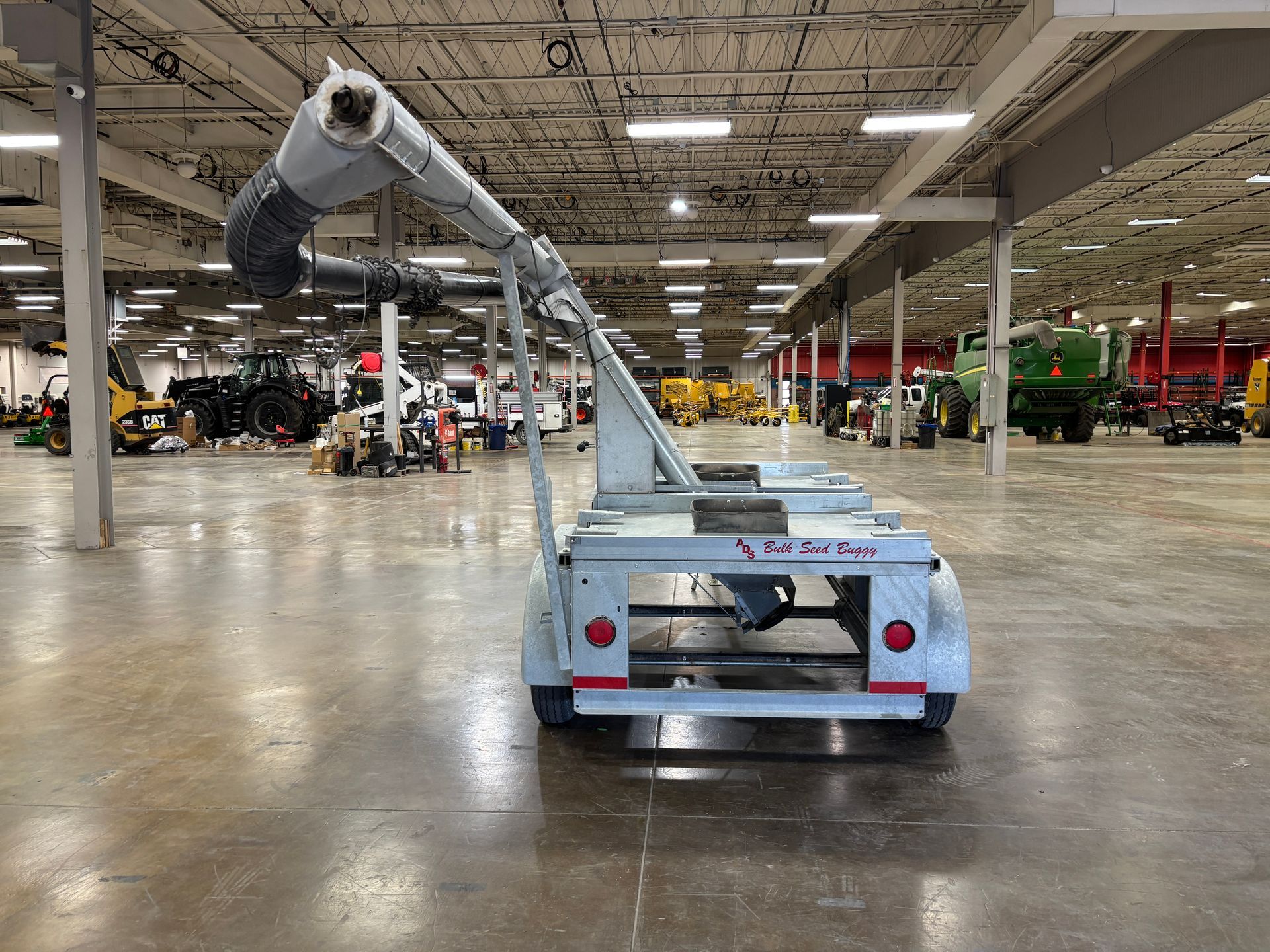 Grey vacuum trailer in a large warehouse.