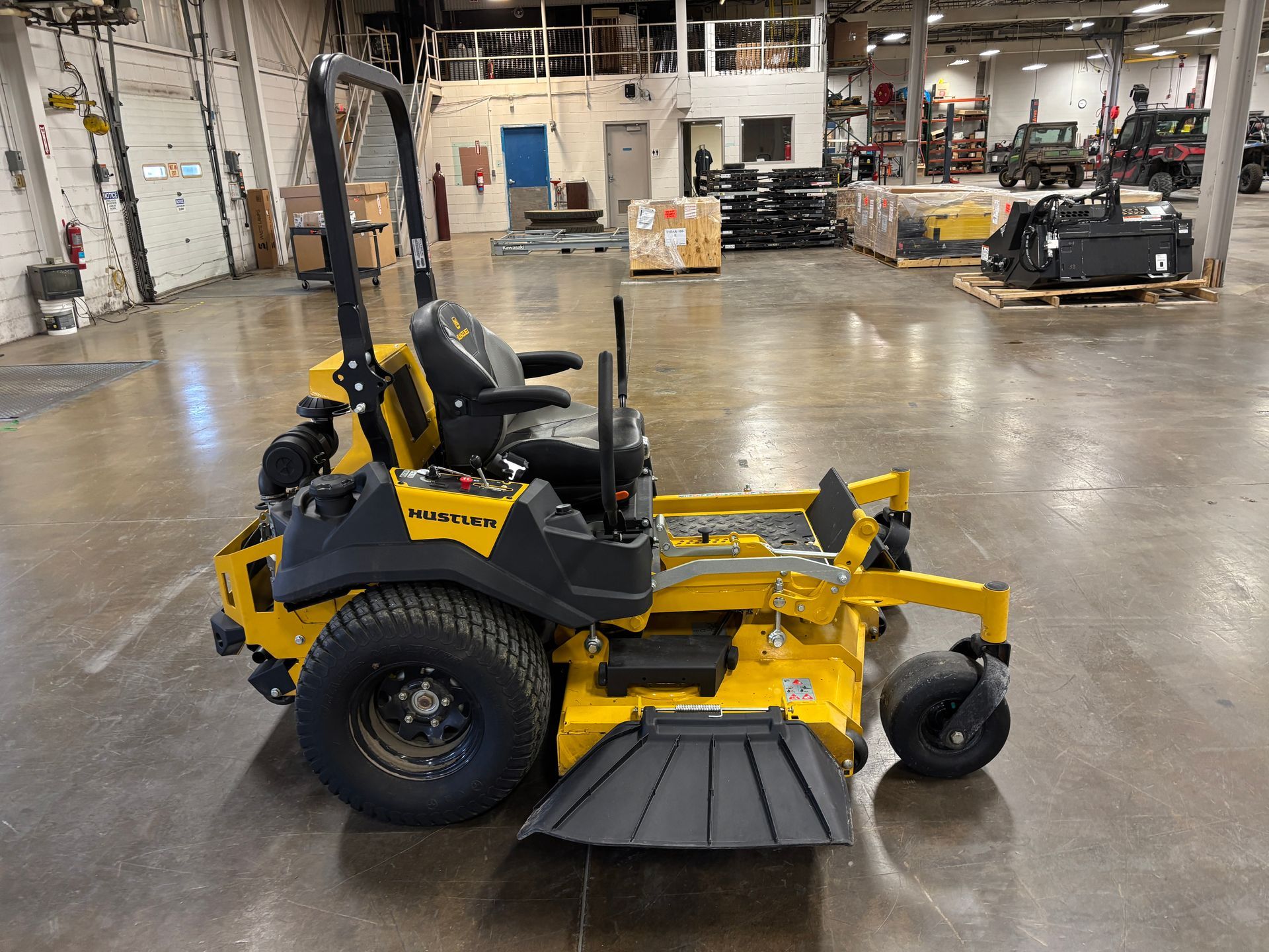 Yellow commercial lawn mower in a warehouse.
