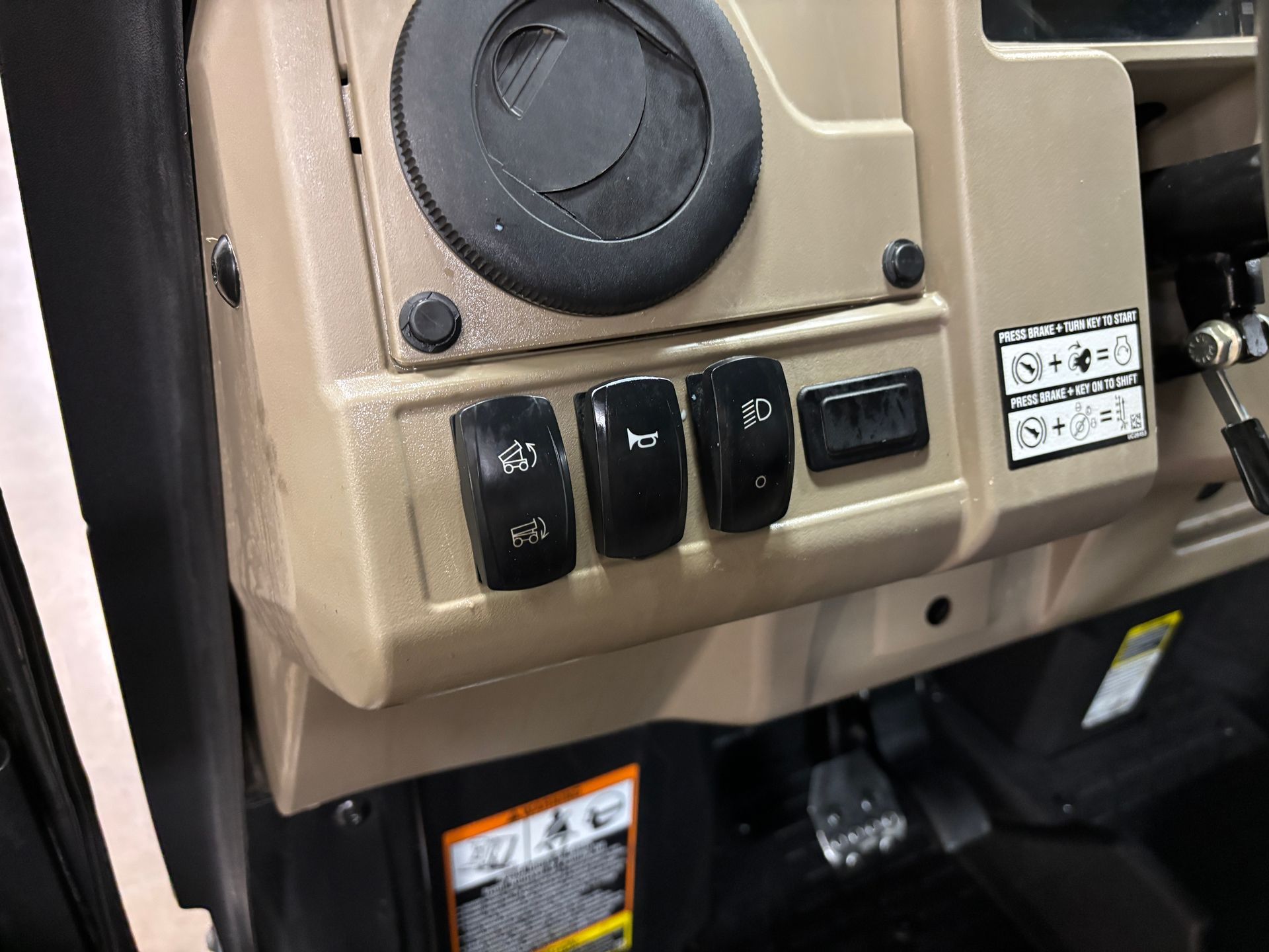 Tan dashboard panel with black toggle switches.