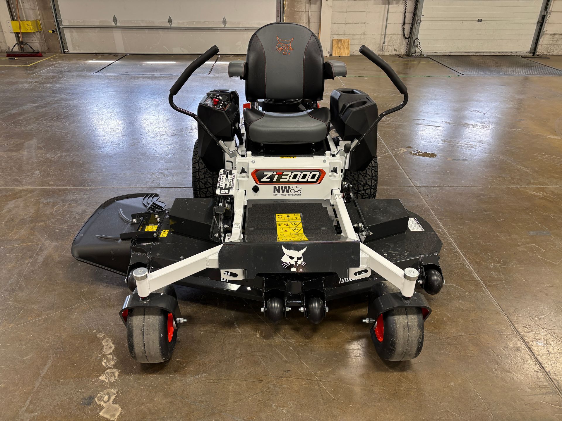 White Bobcat ZT3000 zero-turn mower, front view, in a concrete building.