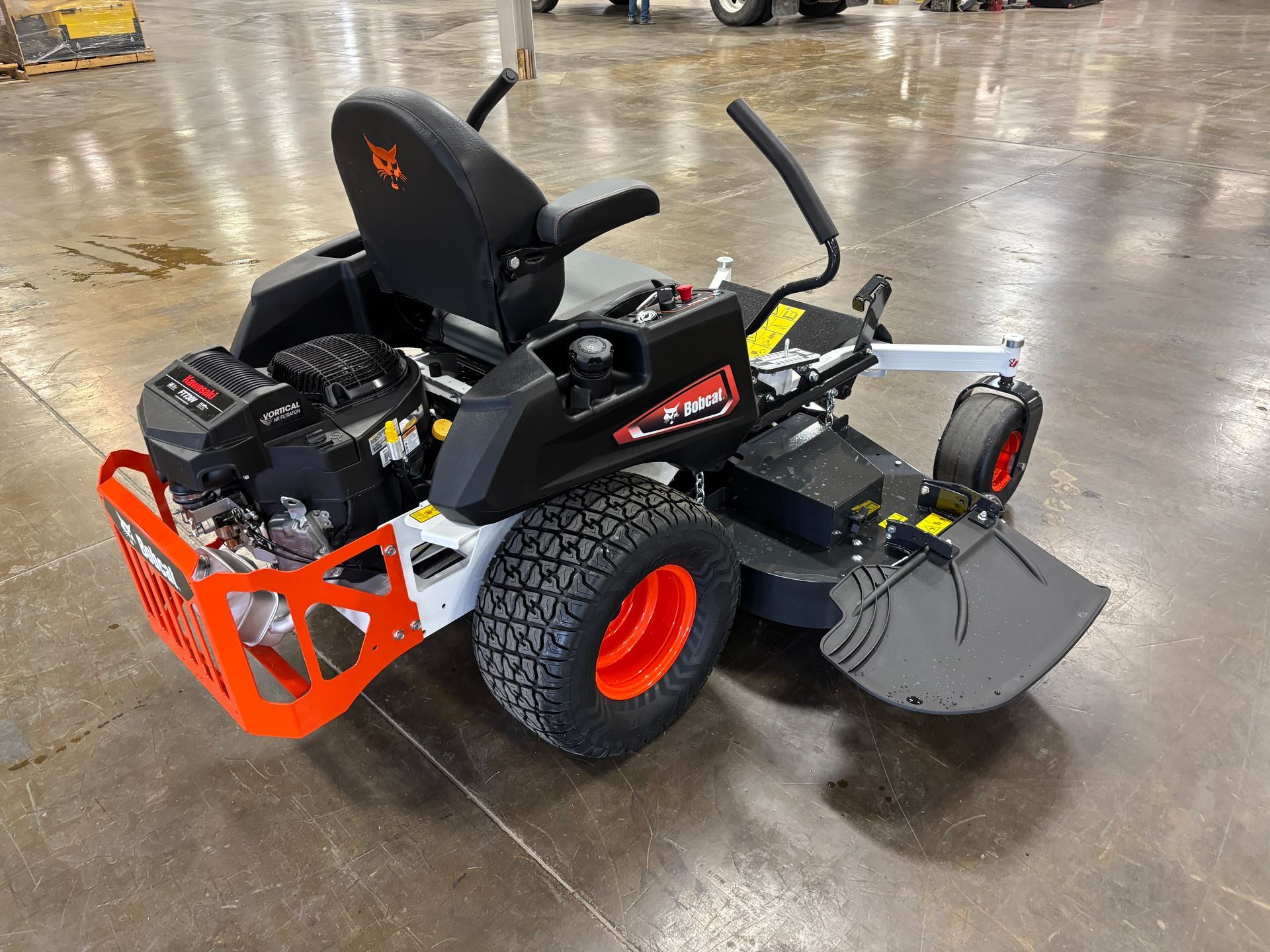 Black and orange Bobcat zero-turn mower on a concrete floor.