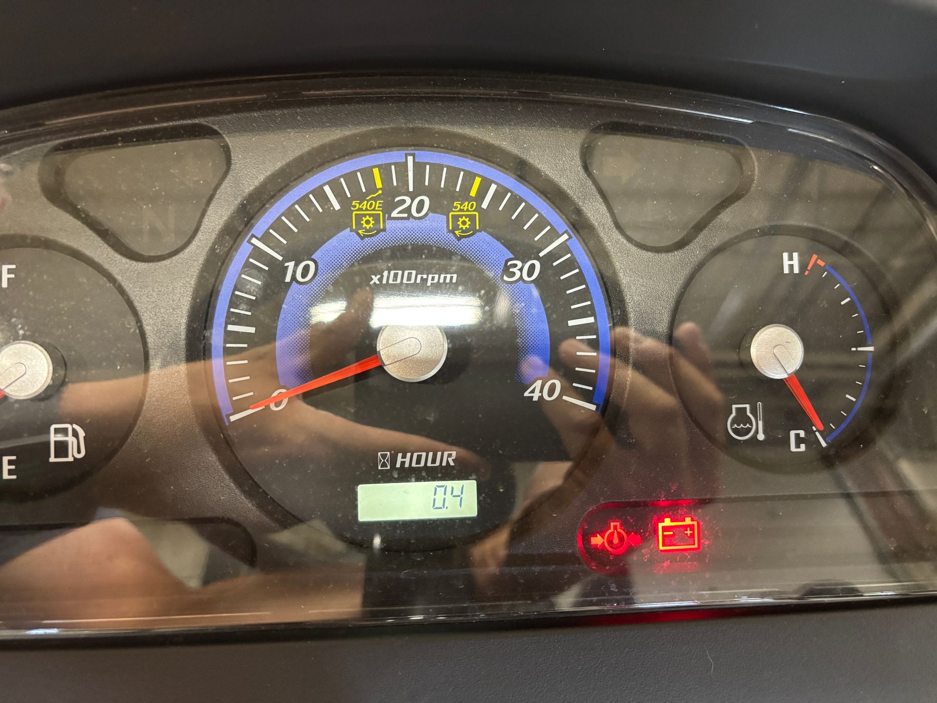 Dashboard showing gauges and warning lights, including engine speed and fuel levels.