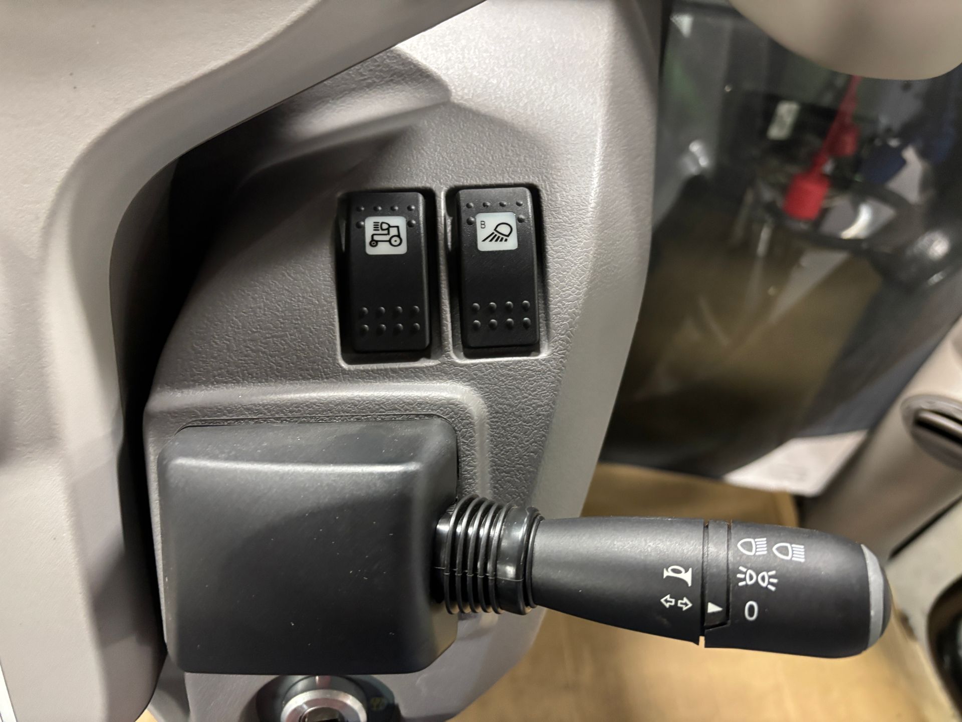 Dashboard with two switches and a turn signal lever.