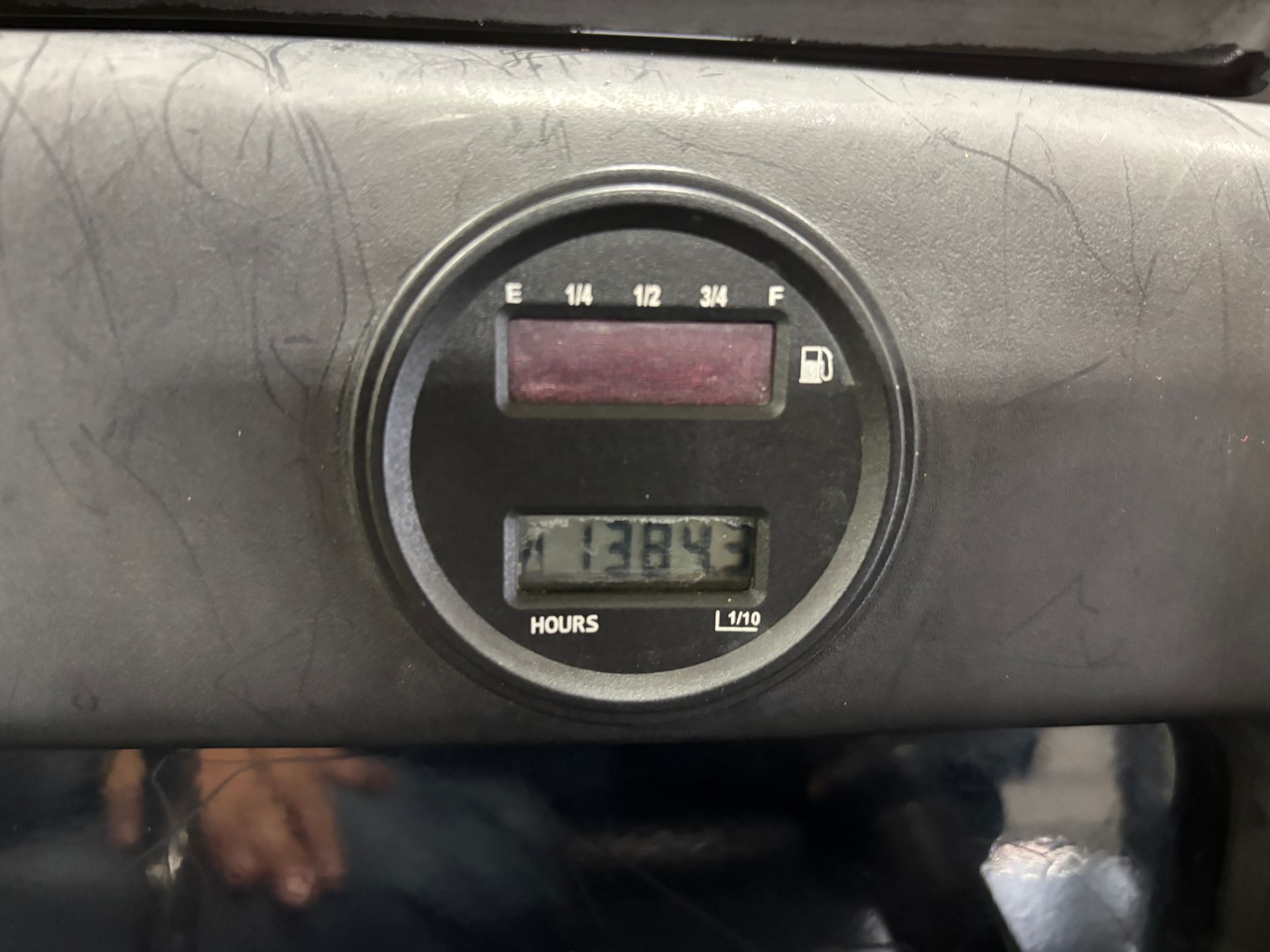 Round gauge with digital display showing 13843 hours and a fuel gauge.