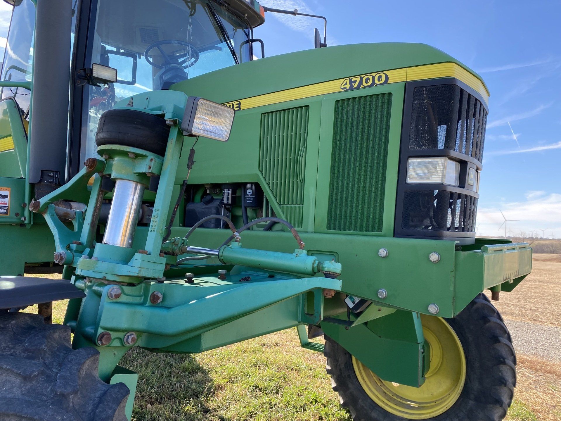 Green John Deere tractor in a field.