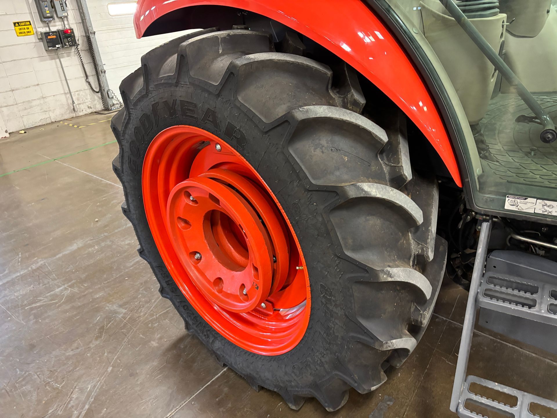 Orange tractor wheel and tire.