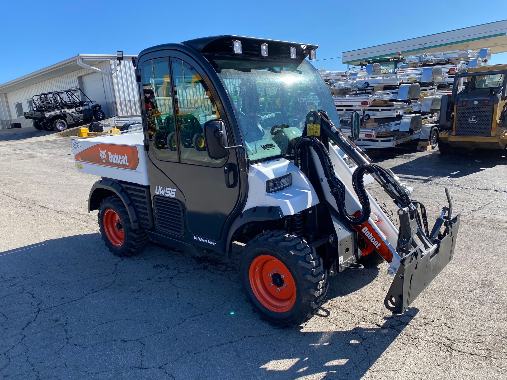 White and black Bobcat utility vehicle with a front loader.