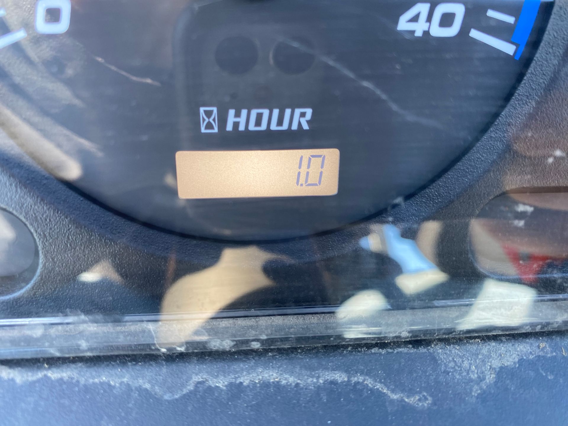 Close-up of a vehicle's dashboard. A digital display shows 