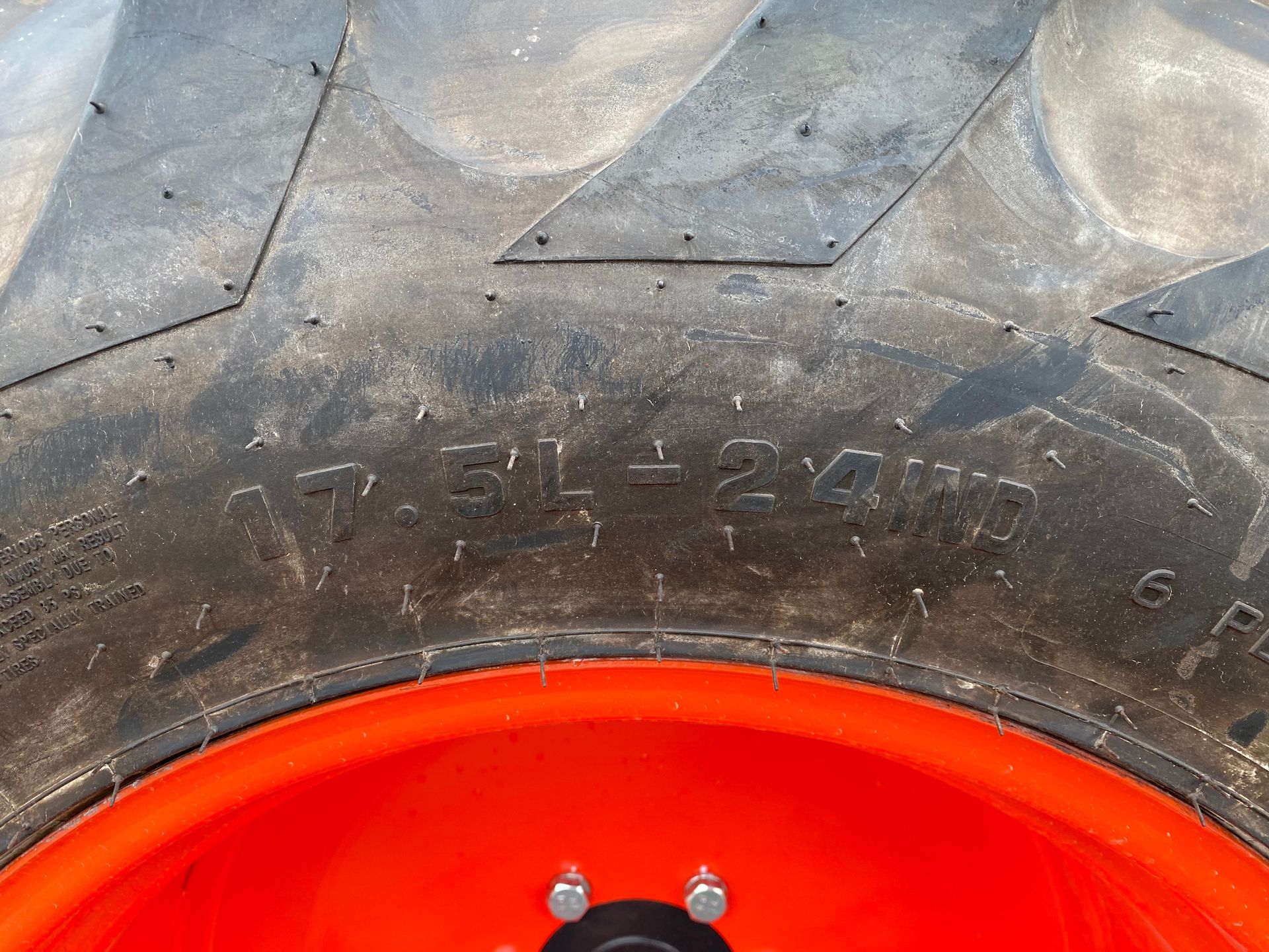 Close-up of a tractor tire showing the size 