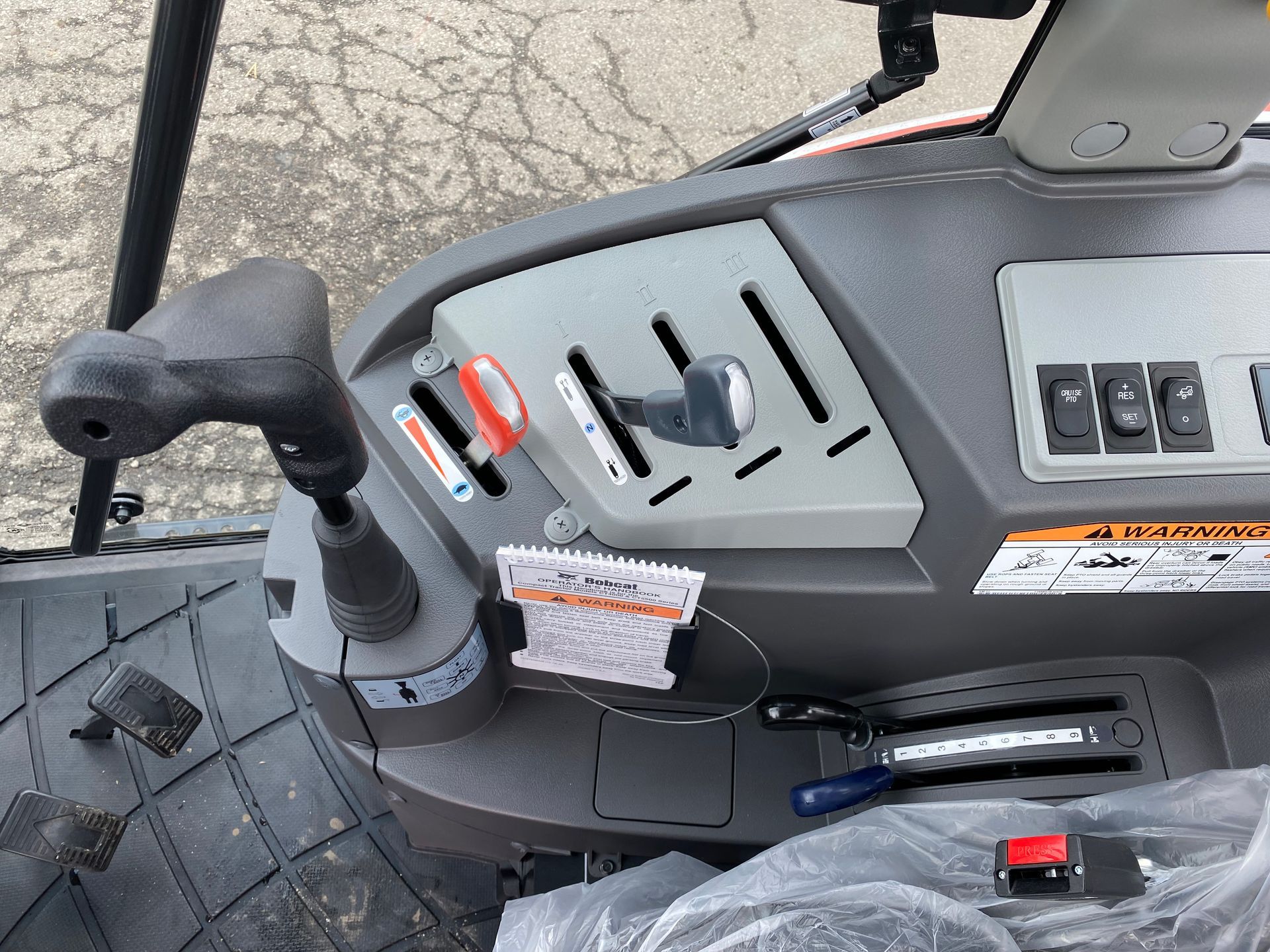 Tractor's interior control panel: gear shift lever, switches, and a few other controls.