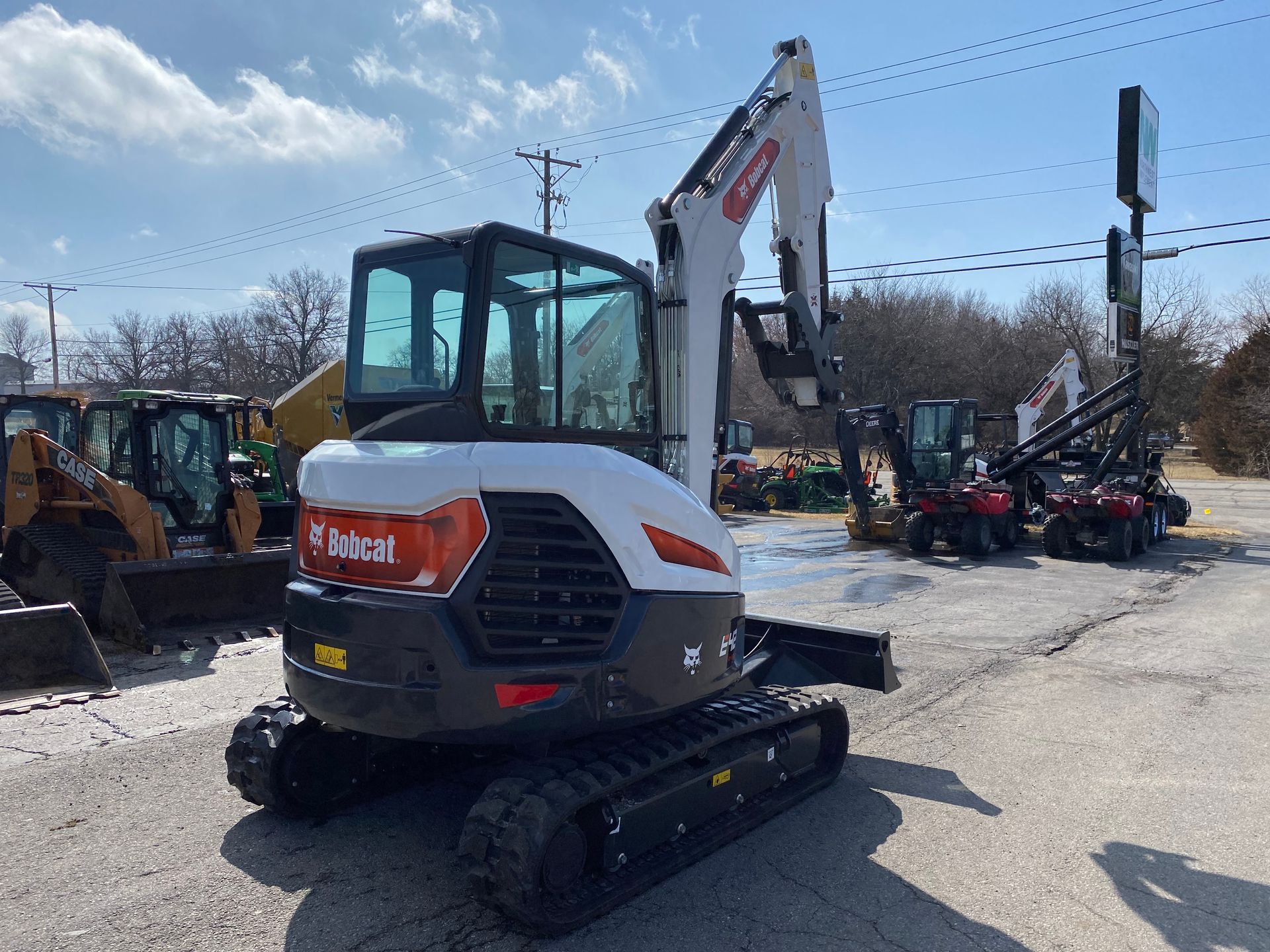 White Bobcat E35 excavator on display at a lot; outdoors, sunny.