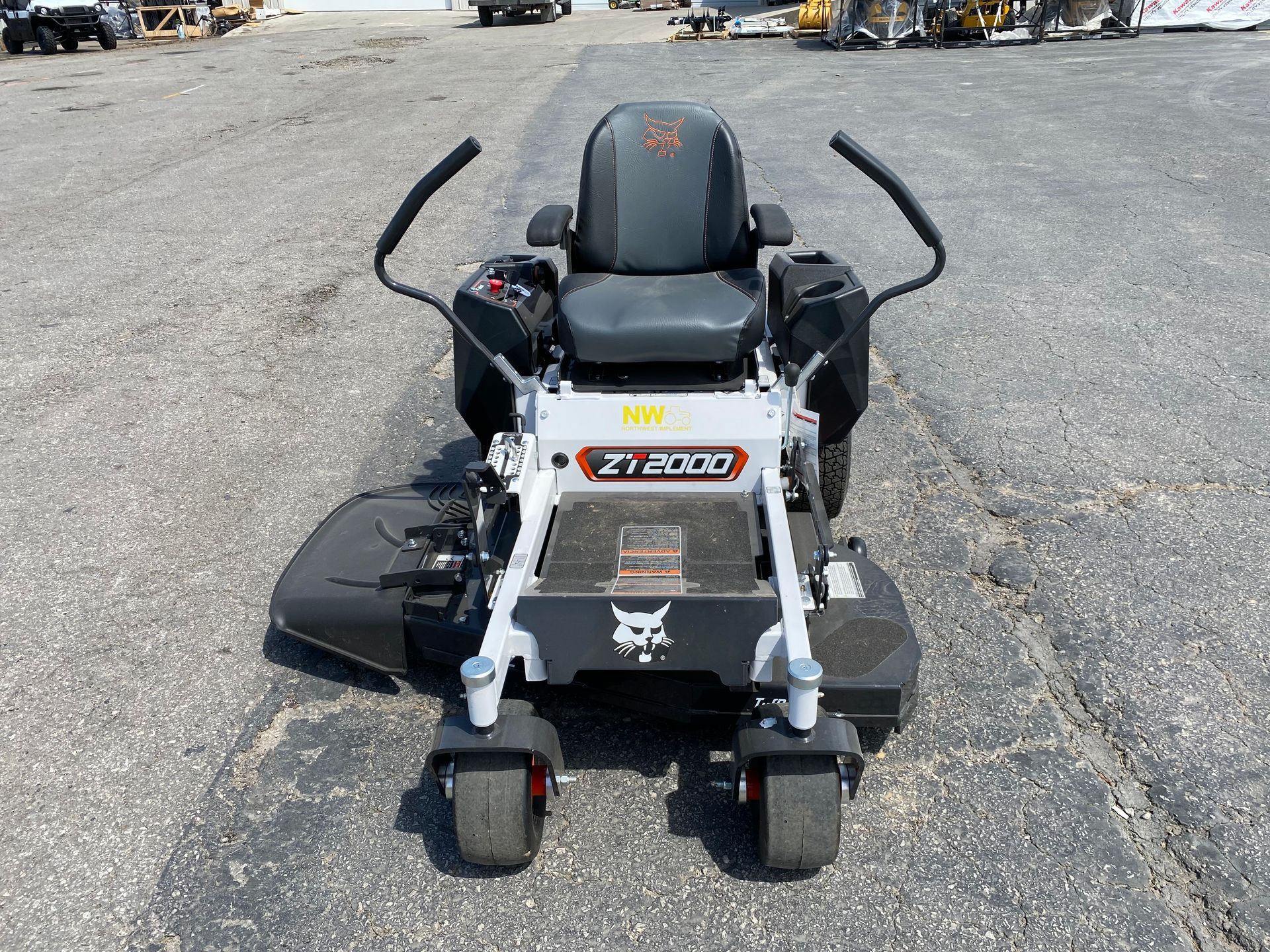 Black and white Bobcat ZT7000 zero-turn mower on asphalt, front view.