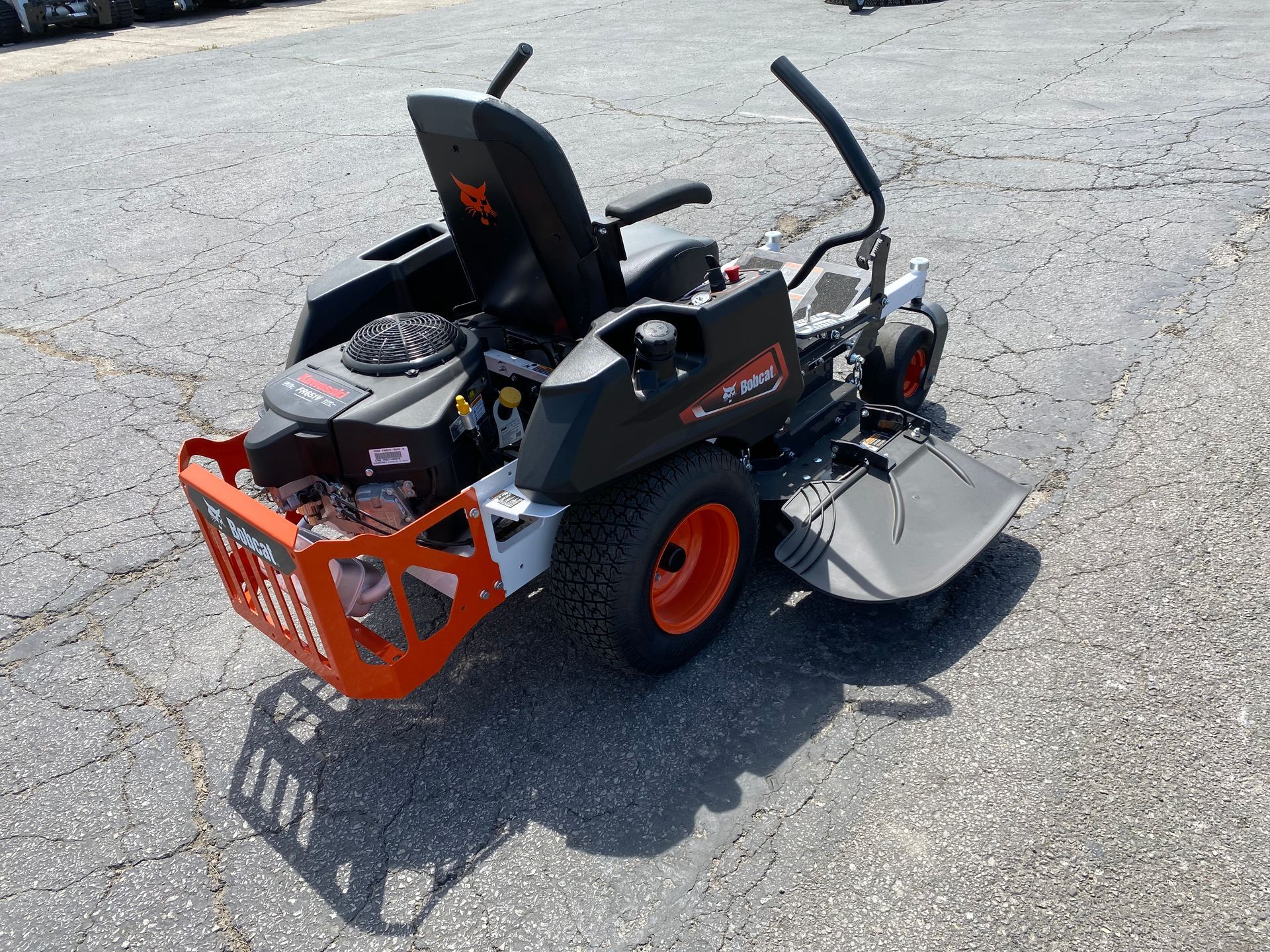 Orange and gray Bobcat zero-turn lawnmower on pavement.