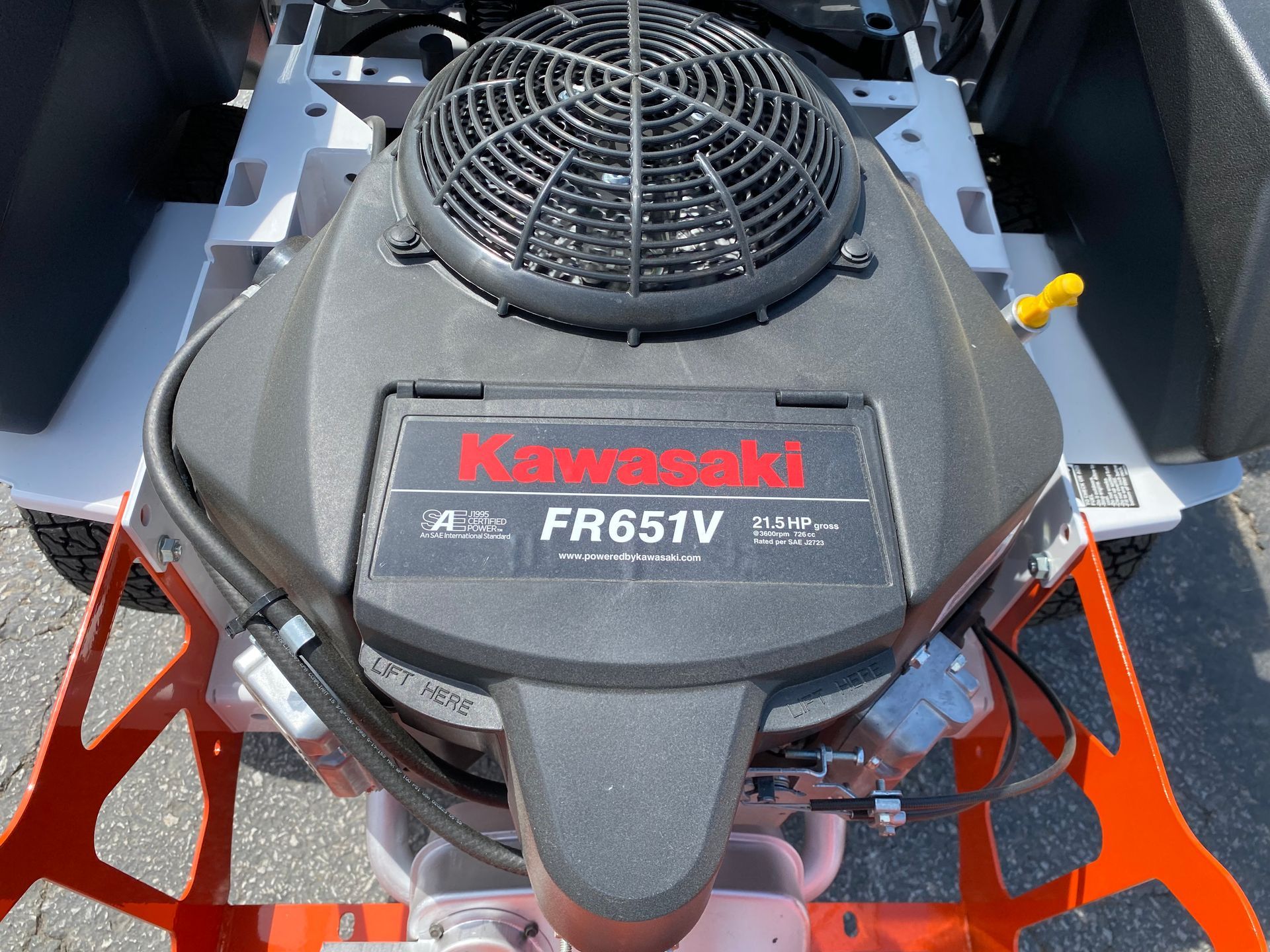 Kawasaki FR651V engine on a riding lawnmower, gray and orange frame.