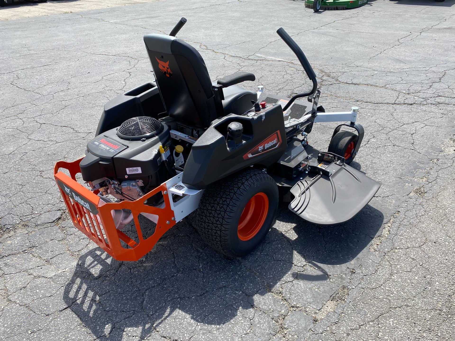 Black and orange Bobcat zero-turn lawnmower on pavement.