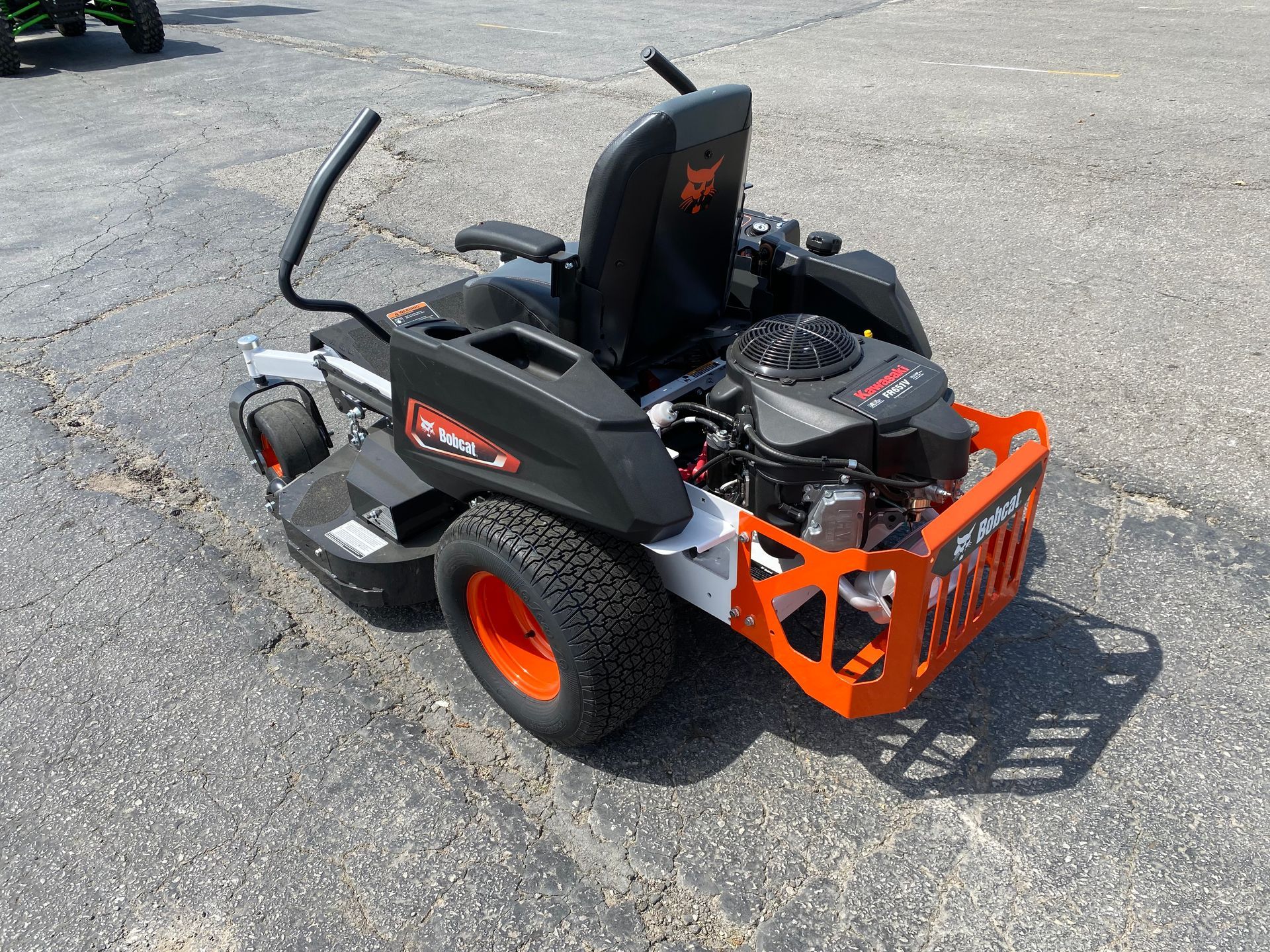 Orange and black Bobcat zero-turn lawnmower on pavement.