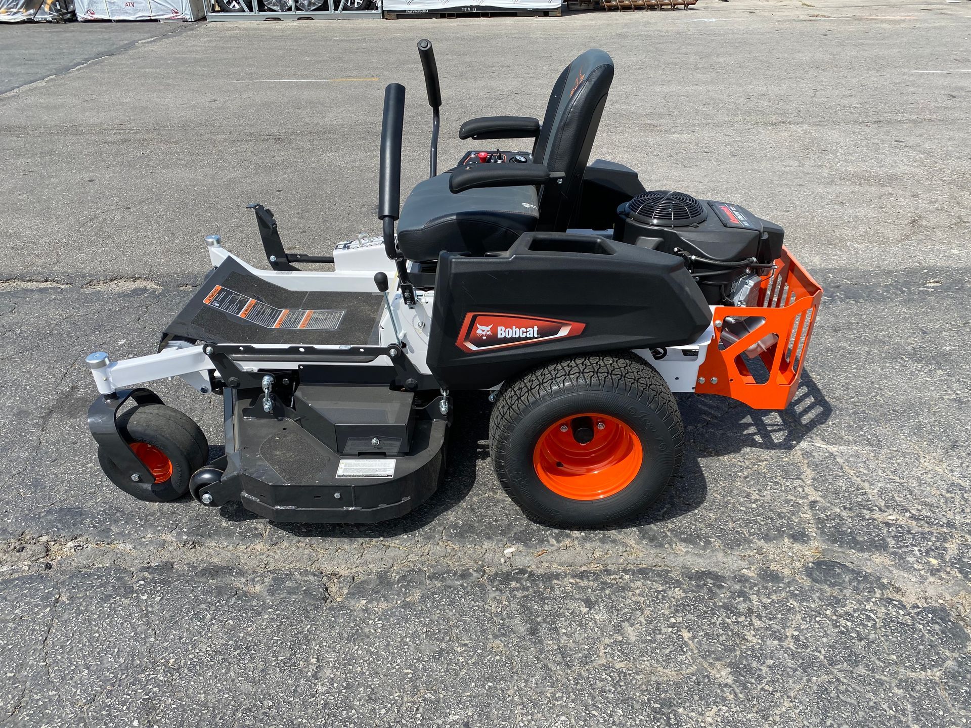 Bobcat zero-turn lawn mower on asphalt, with orange and black accents.