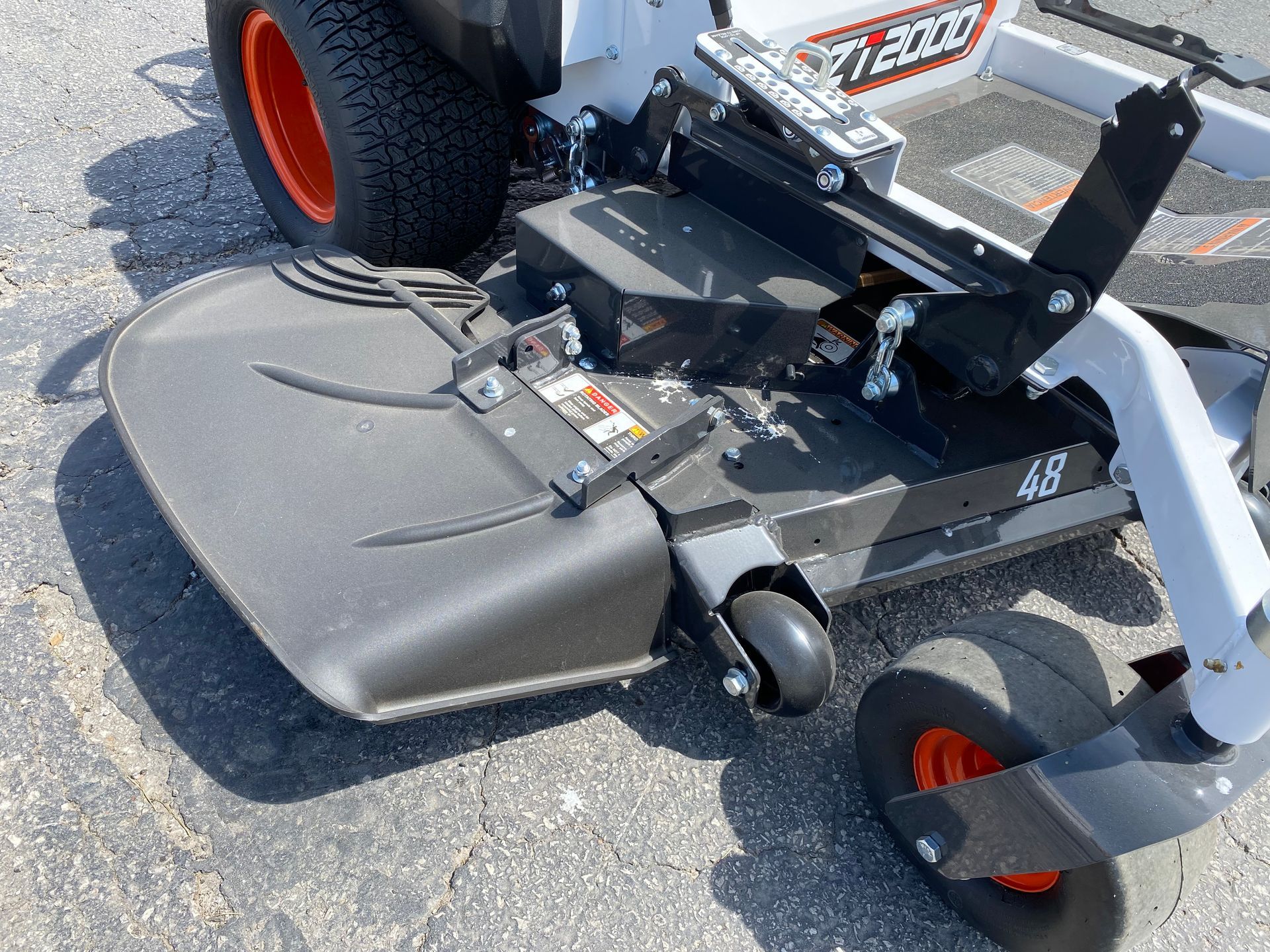Bobcat zero-turn mower with a 48-inch deck; black and orange wheels, black deck, white body.