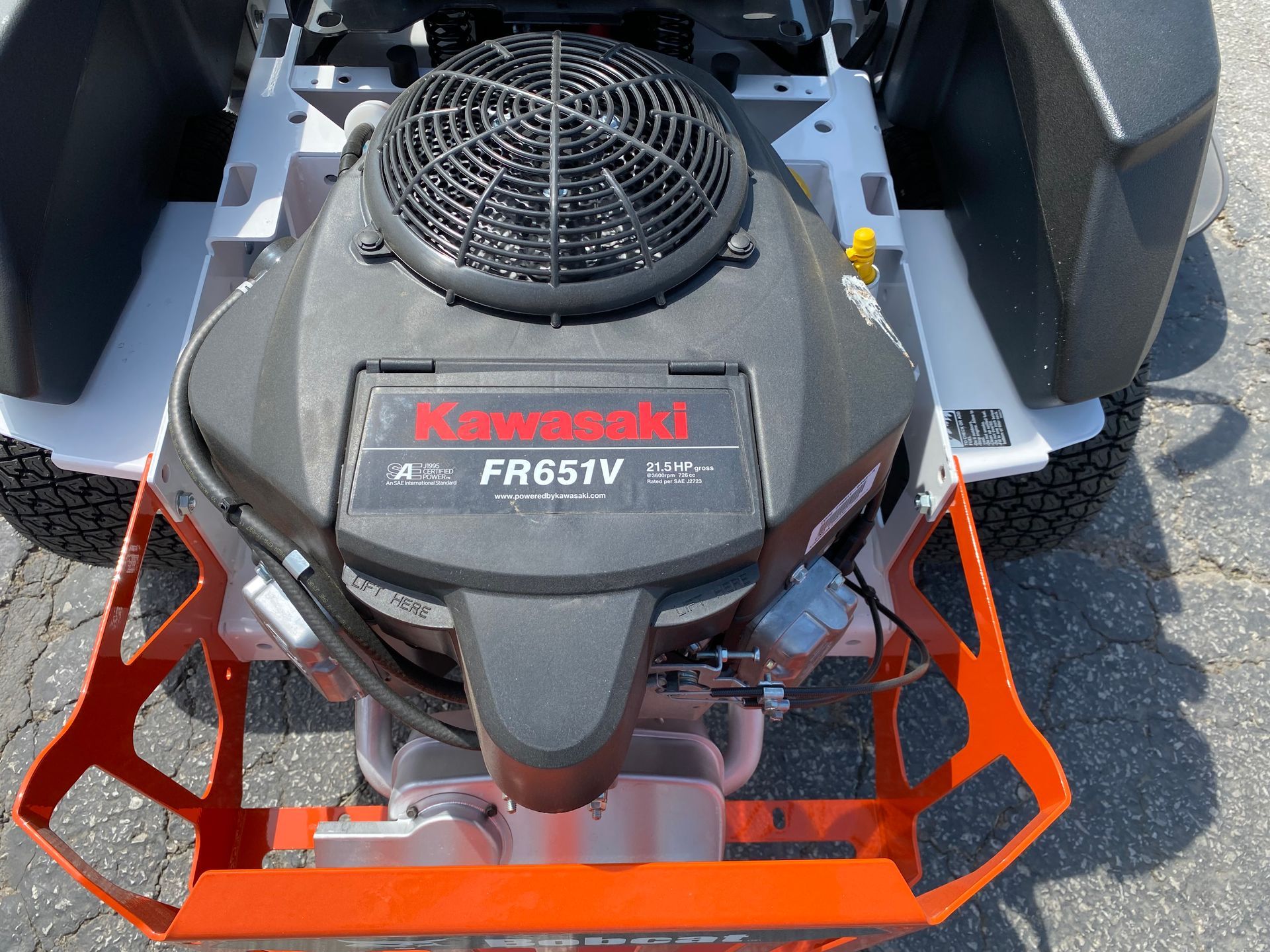 Top view of a zero-turn lawn mower engine with a Kawasaki FR651V on a concrete surface.