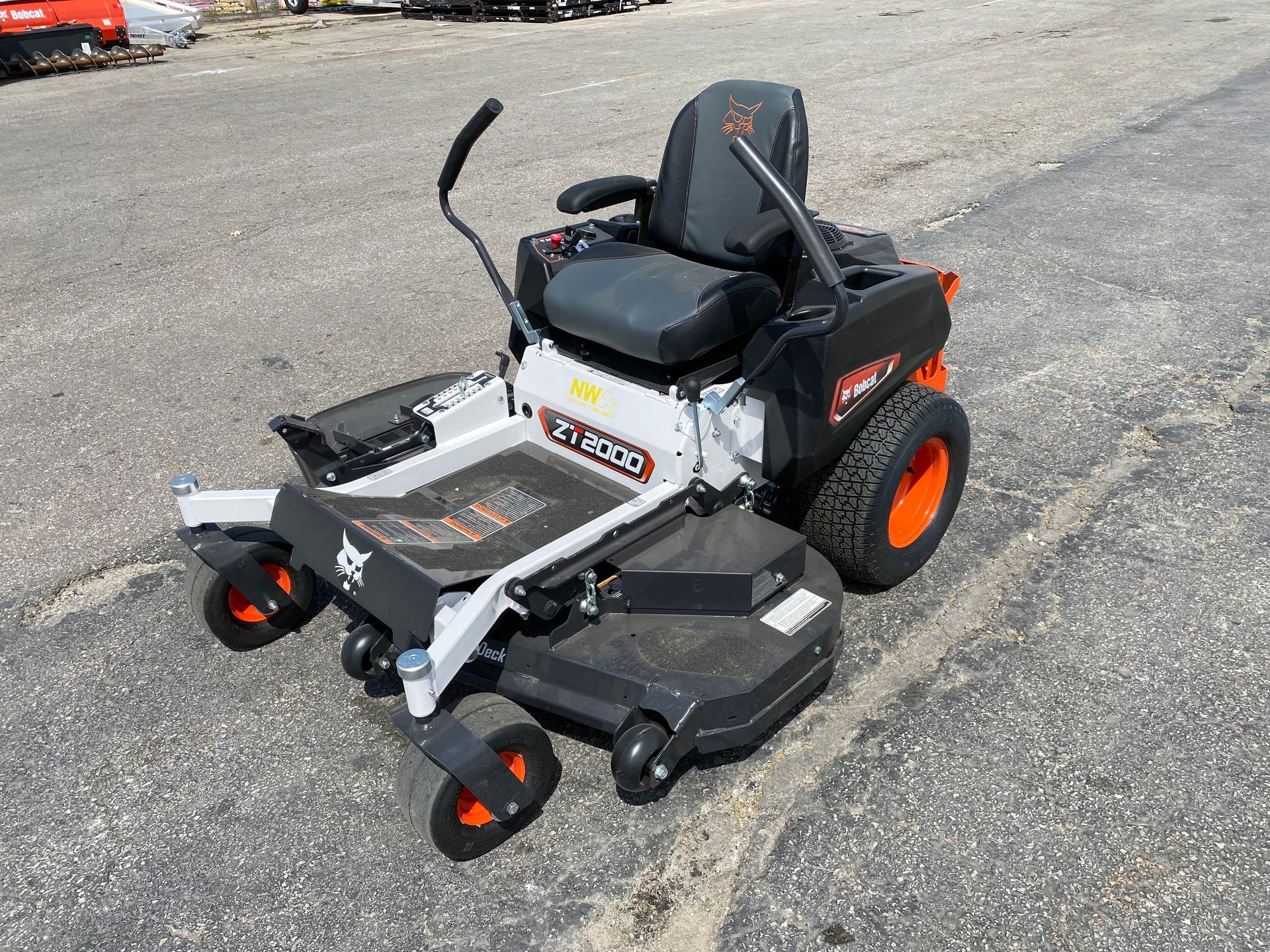 Bobcat XRZ zero-turn lawn mower on asphalt, orange and black accents.