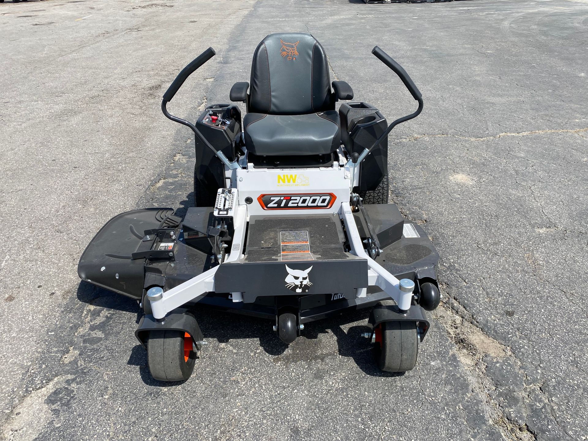 A gray and black Bobcat ZT2000 zero-turn mower on asphalt.