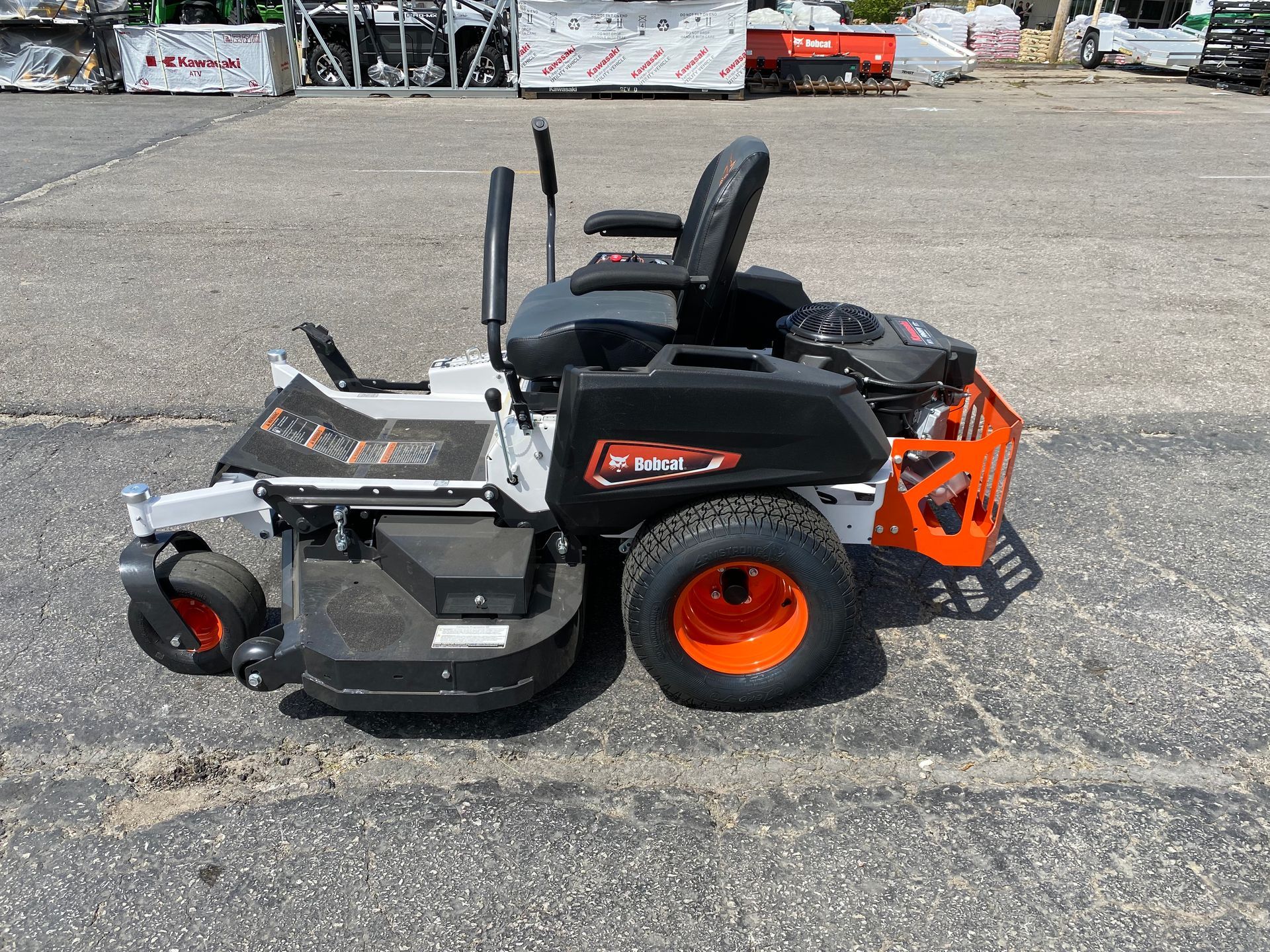 Bobcat zero-turn mower on asphalt, with orange and black accents.
