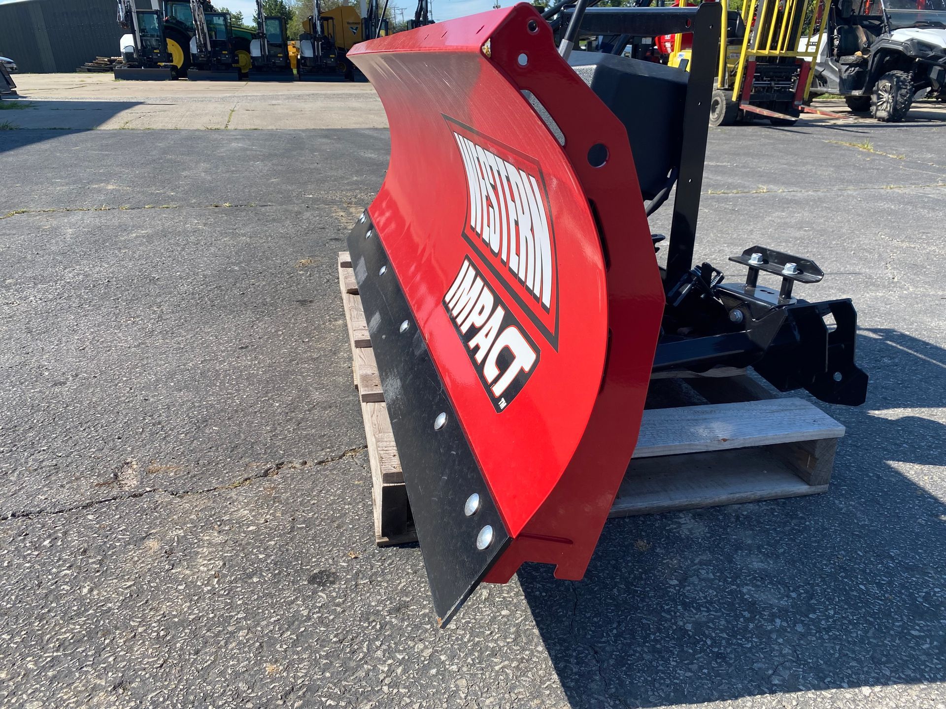 Red Western Impact blade on a pallet, outdoors, side angled shot.