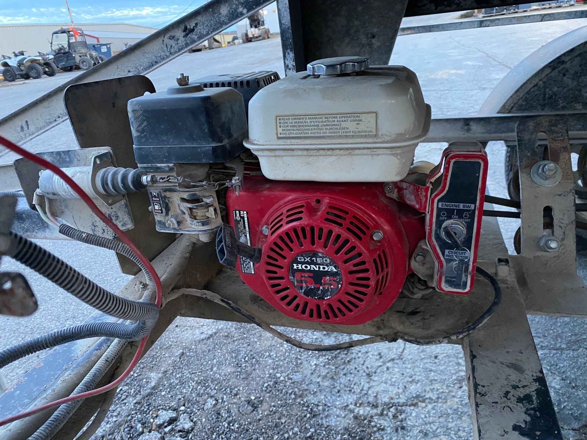 Red Honda engine with black air filter, mounted on machinery.