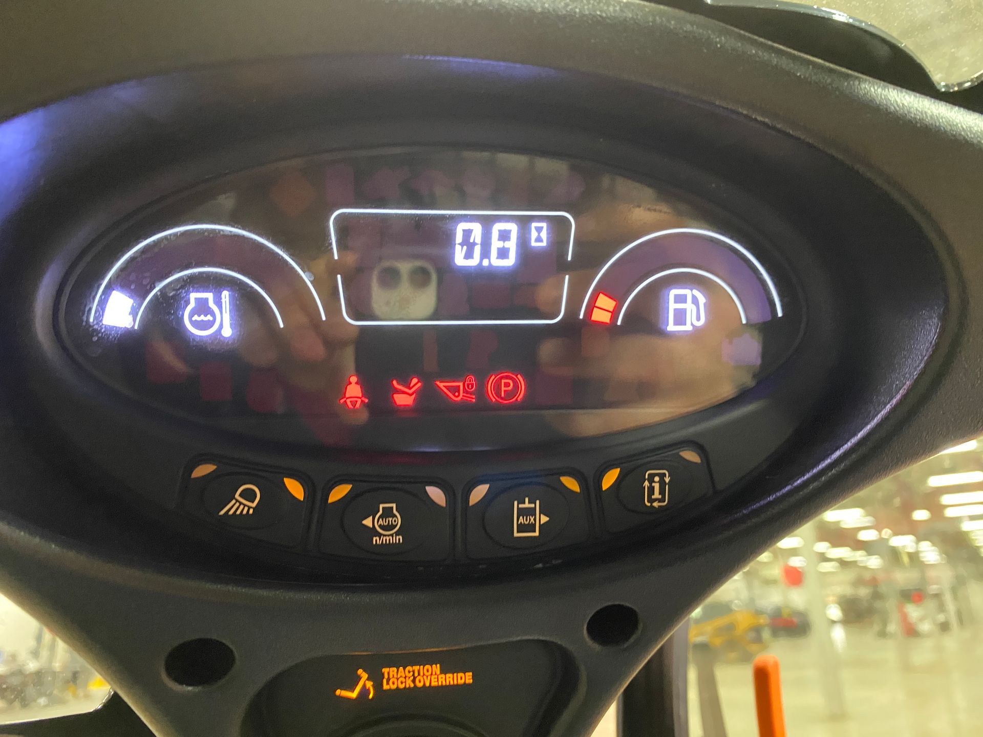Dashboard showing gauges and warning lights, including fuel, temperature, and low oil pressure.