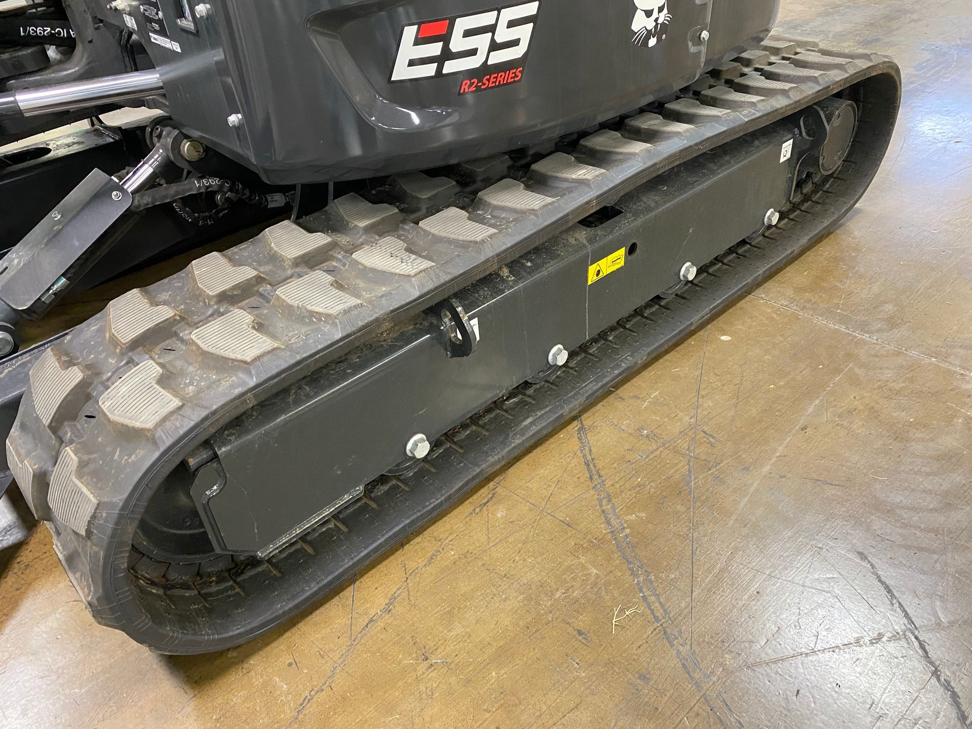 Black track of an excavator, with the model number 