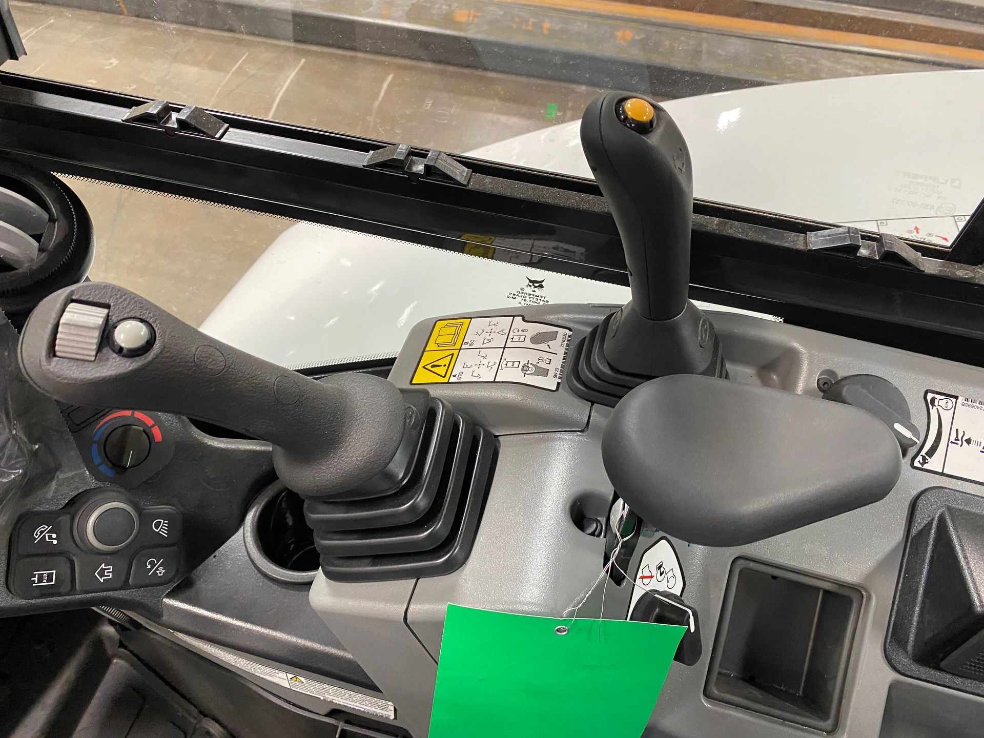 Control panel with joysticks and buttons in a construction vehicle.