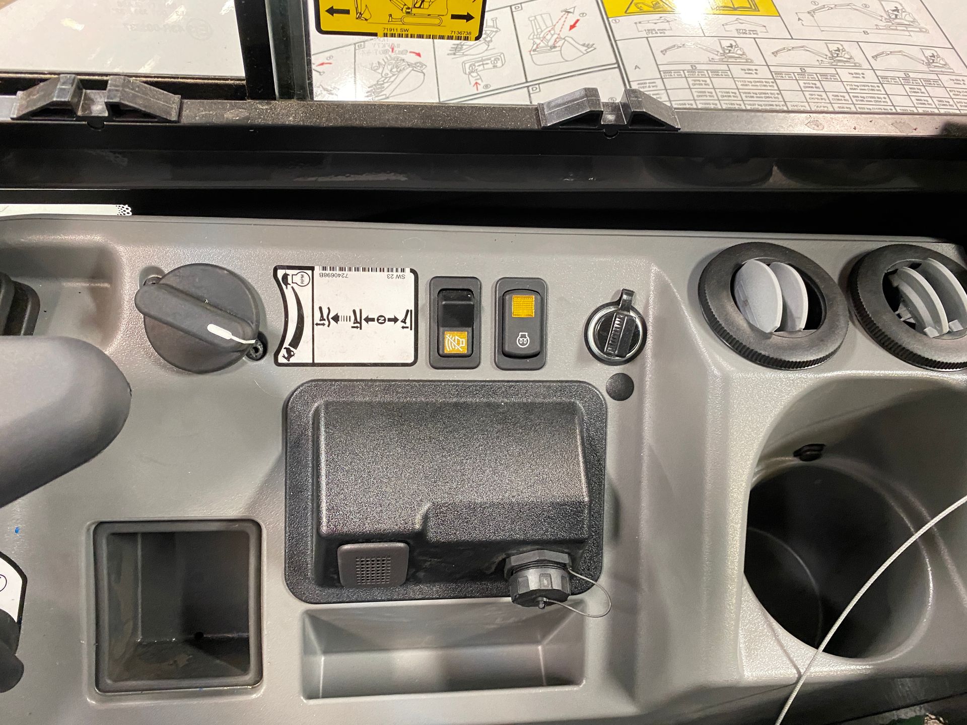 Dashboard with knobs, switches, and air vents in a vehicle's interior.