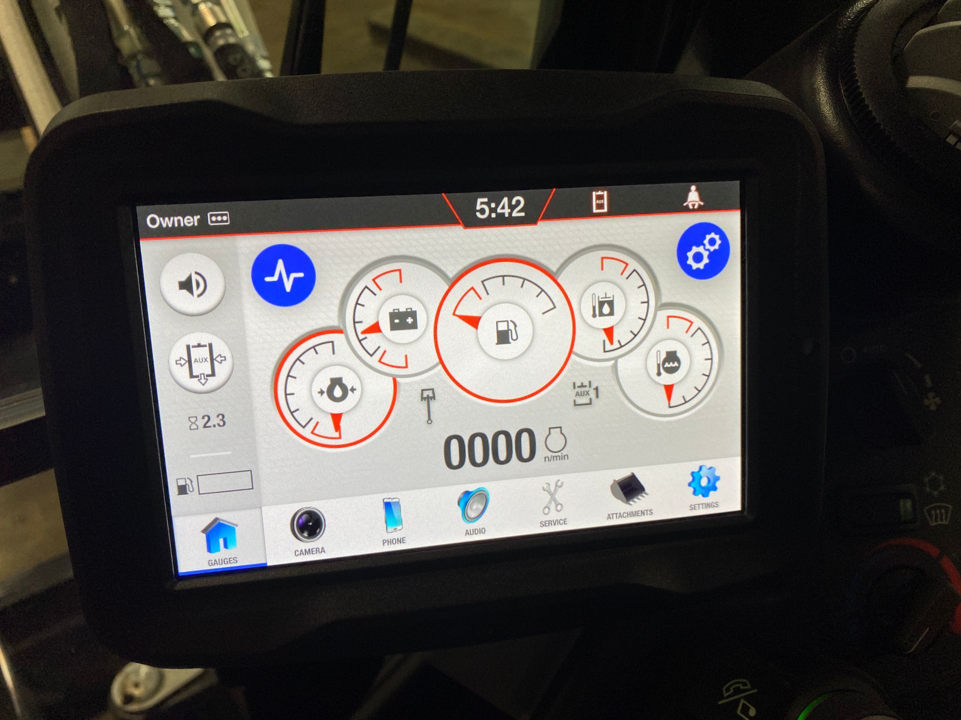 Motorcycle dashboard displaying gauges: speedometer, fuel level, battery, and other metrics. Gray and blue interface.