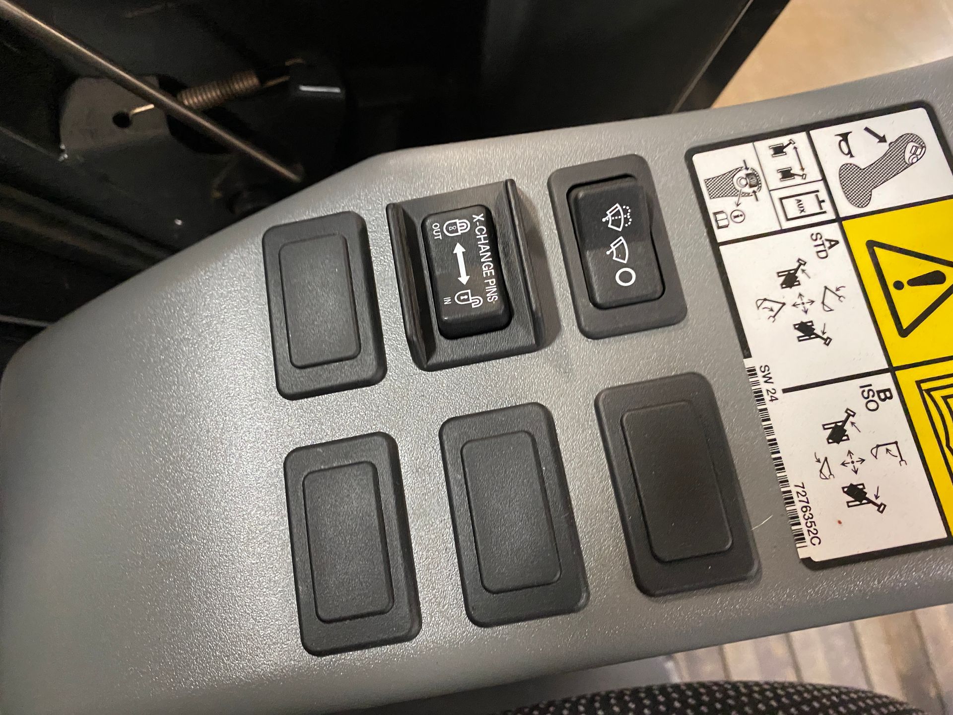 Control panel with six black switches and a light gray background.