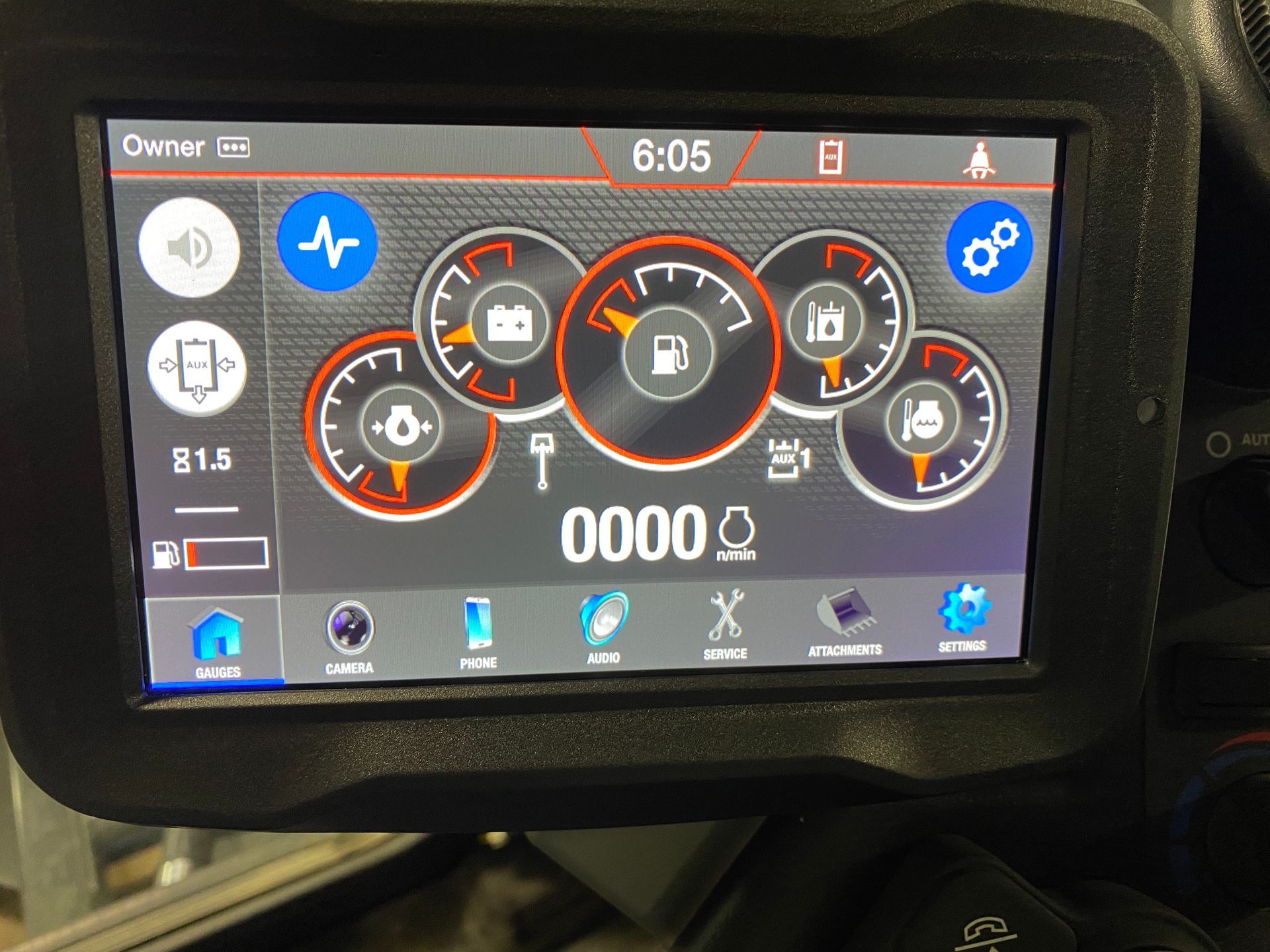 Dashboard display with gauges, icons, and digital readings. Black and orange design, reading 0000.