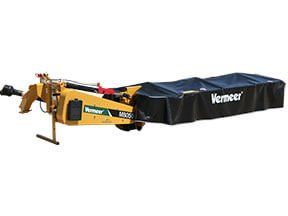 Yellow and black Vermeer mower, attached to a tractor, for cutting hay.