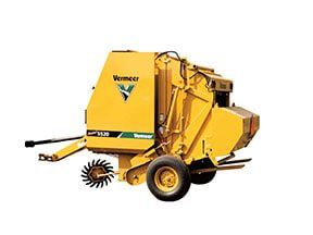 Yellow Vermeer VR120 round baler on a white background.
