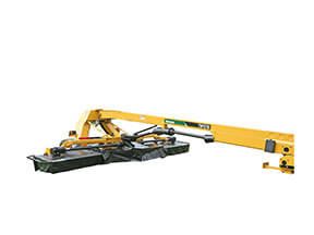 Yellow and black boom mower attached to a tractor, cutting grass.
