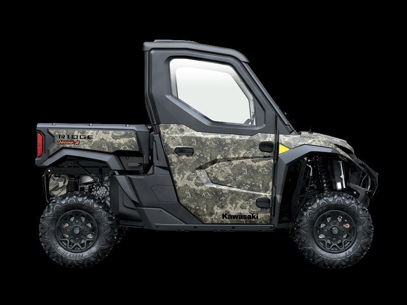 Side view of a camouflaged Kawasaki Ridge side-by-side UTV with a black roof and large wheels.