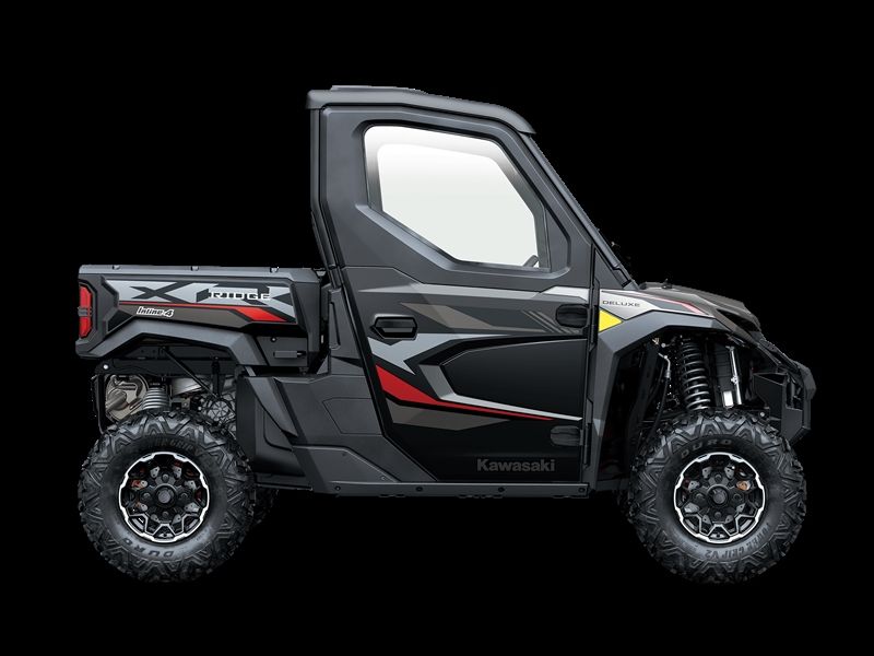 Black Kawasaki side-by-side utility vehicle with a closed cab and rugged tires against a black background.