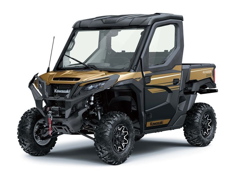 Gold and black Kawasaki UTV with cab, black wheels, and pickup bed on white background.