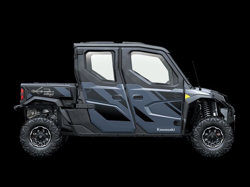 Dark gray Kawasaki side-by-side utility vehicle with black geometric graphics, on a black background.