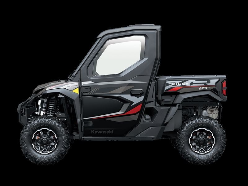 Black Kawasaki UTV side view, off-road vehicle with enclosed cab, black and red accents, large tires.