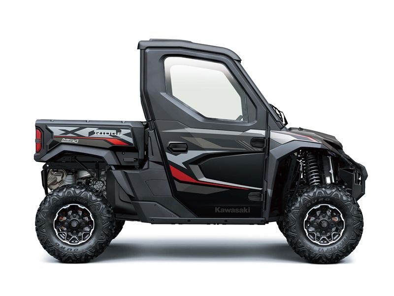 Black Kawasaki UTV with large tires, side door, and a bed.